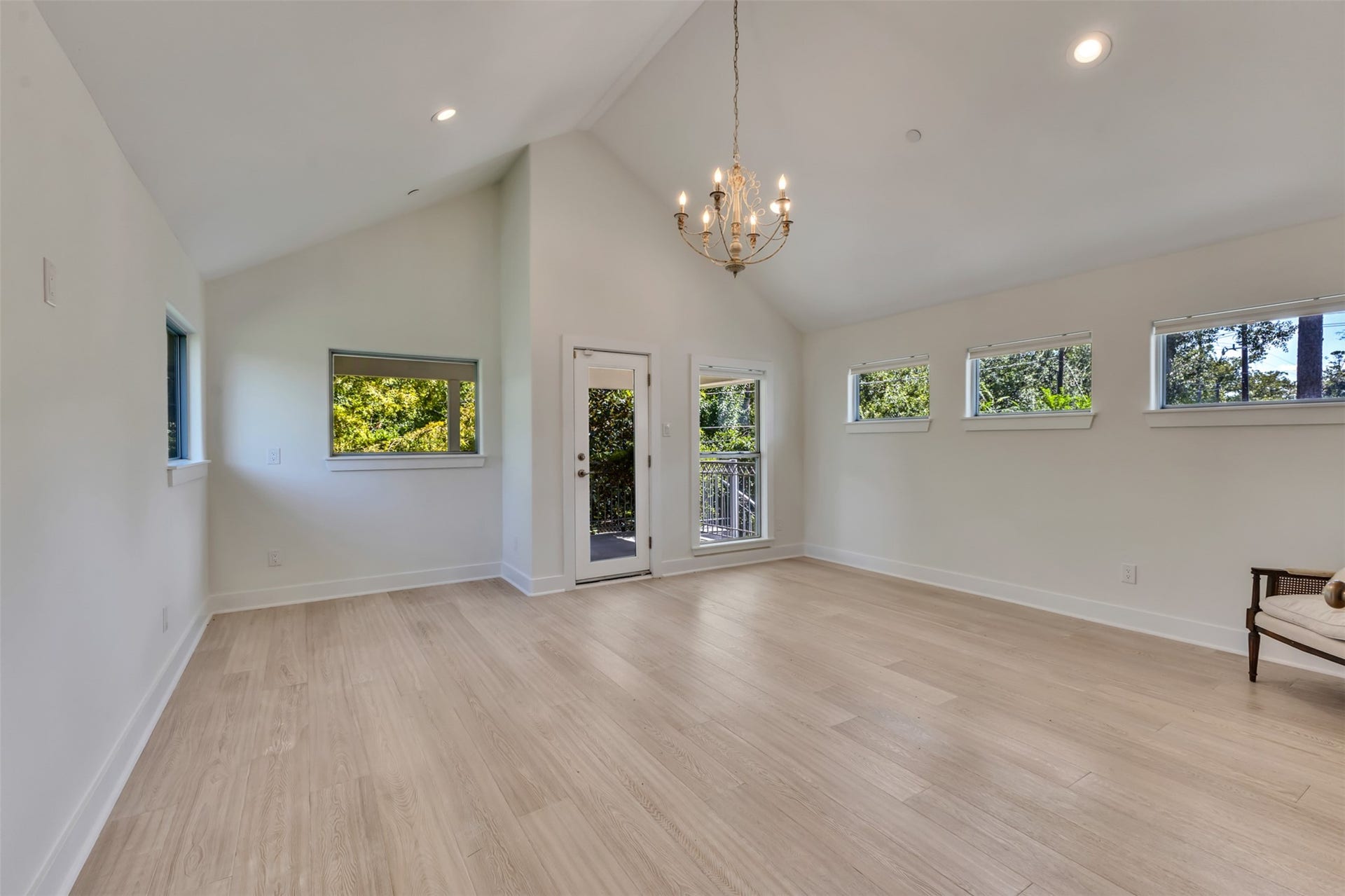 Expansive second-floor ensuite bedroom, large enough to serve as a second primary suite. Features soaring vaulted ceilings, room for a private sitting area, a dedicated entry, and direct access to a covered balcony.
