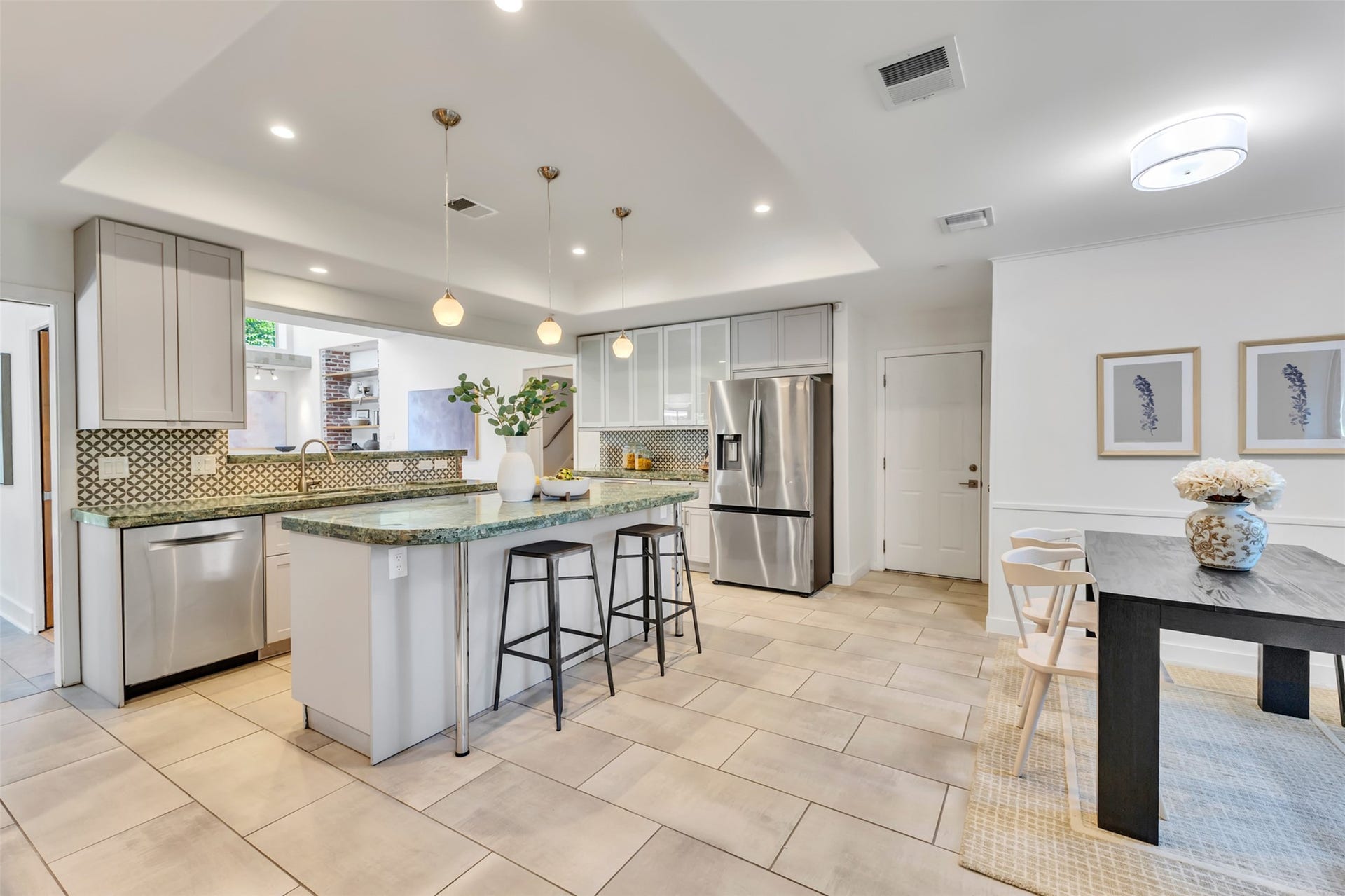 The kitchen features stainless steel appliances, granite countertops, and updated soft close cabinets and drawers. (2023)