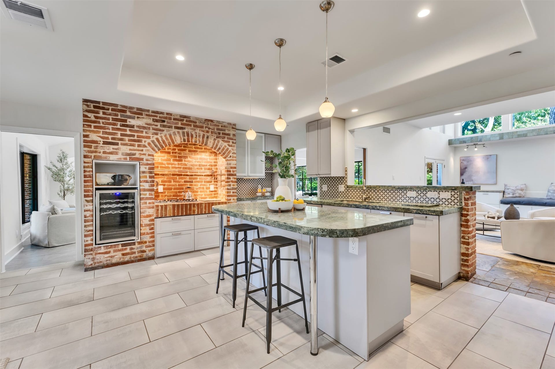 The kitchen hearth is crafted by historic reclaimed church brickhonoring one of the home's original features.