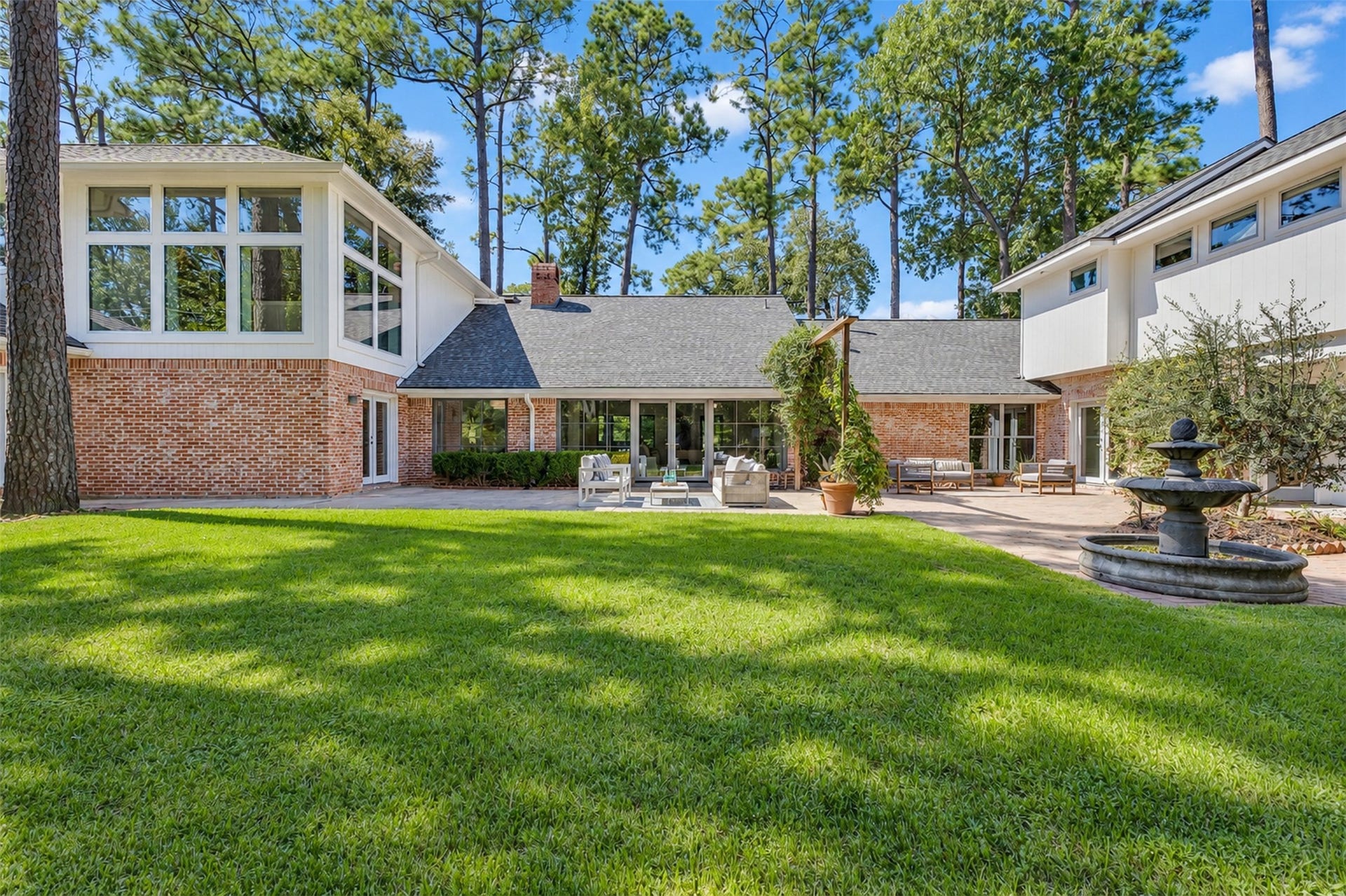 Exceptional outdoor living with abundant space for multiple seating areas, a future pool, extended lawn, or custom play area.
