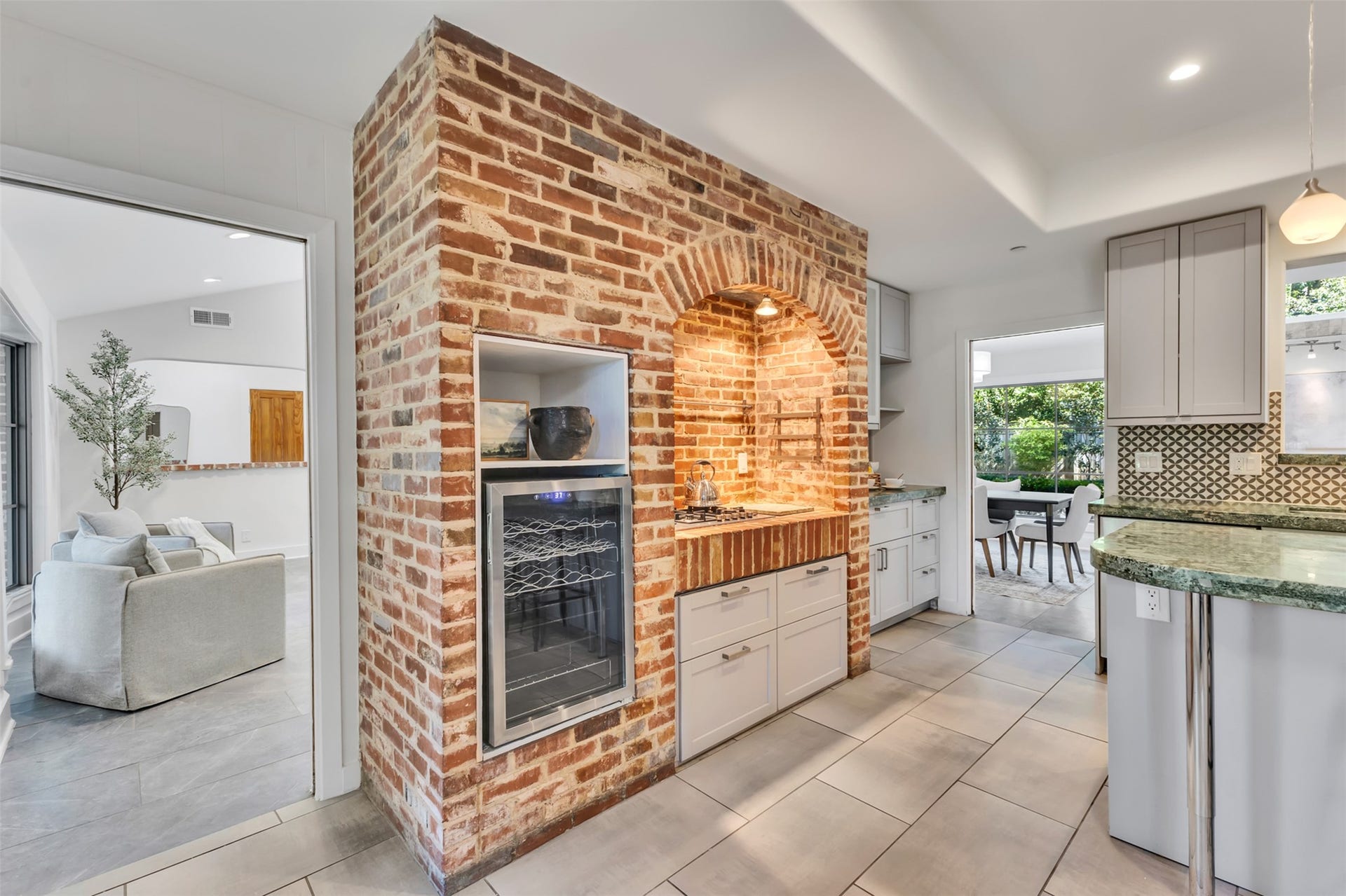 This kitchen corner makes cooking and entertaining an absolute pleasure featuring a gas cooktop and a built in beverage/wine cooler.