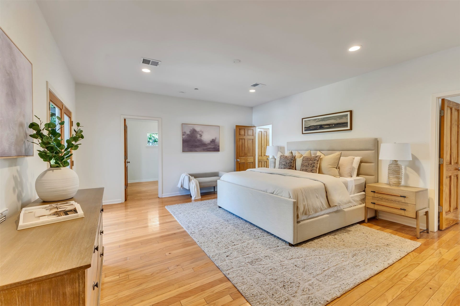 Expansive primary retreat anchored by warm wood floors and double glass doors leading to the outdoor patio. Complete with two versatile flex spacesideal for a home office, workout area, or an additional walk-in closet, offering endless opportunities to suit your lifestyle.