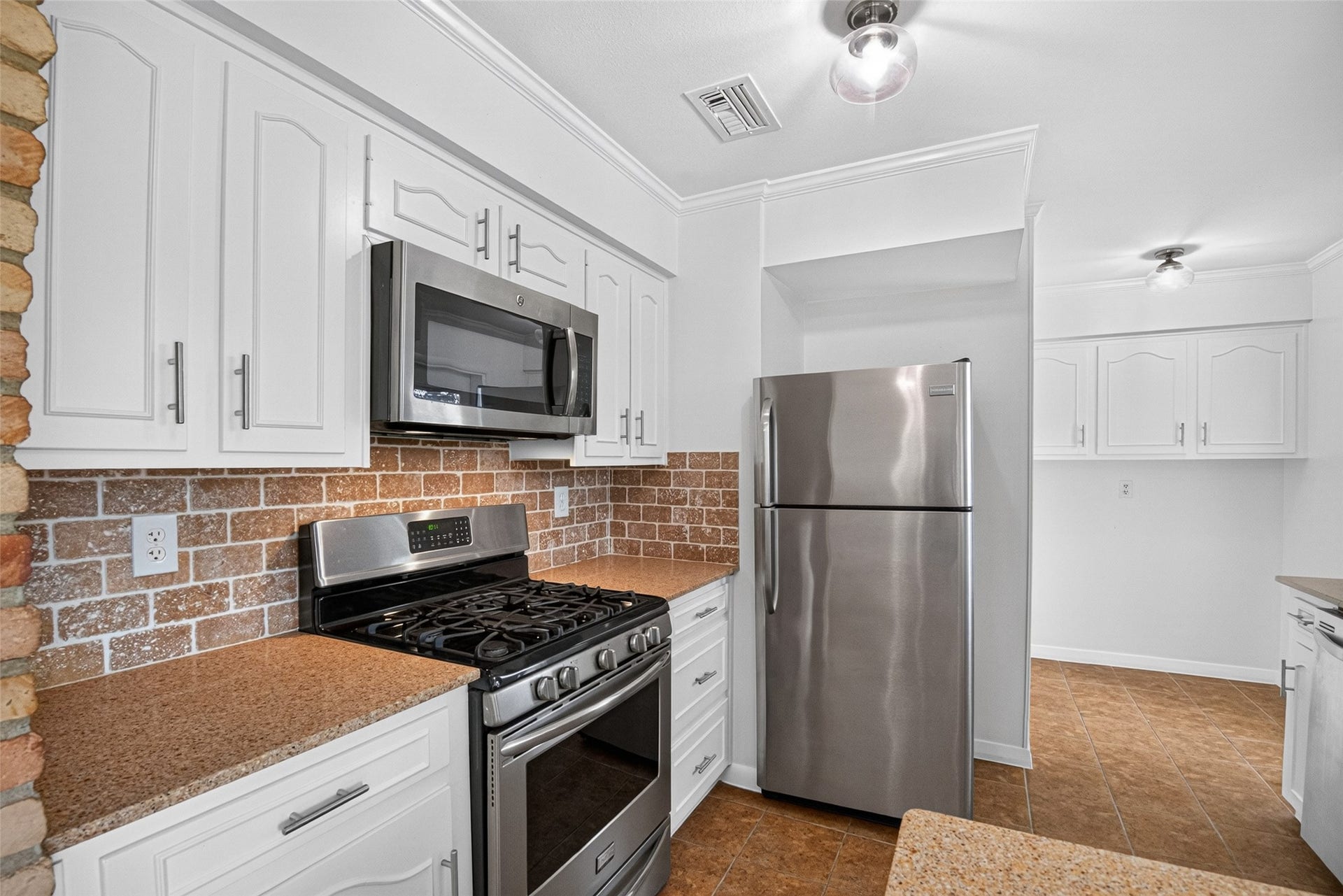 11227 Greenwillow Street, Houston, TX 77035 5-Burner Gas Stove and microwave! Refrigerator included too. Lots of upper and lower cabinets with brushed nickel hardware pulls.