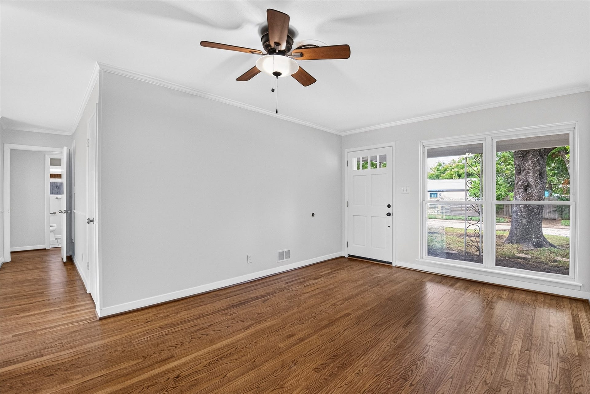 11227 Greenwillow Street, Houston, TX 77035 Another view of living room with ceiling fan and crown molding.