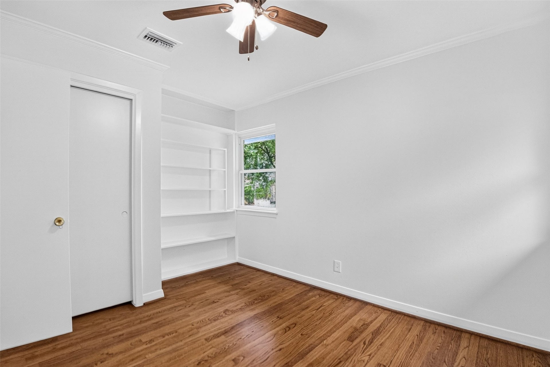 11227 Greenwillow Street, Houston, TX 77035 View of closet and built-n shelves in guest bedroom.