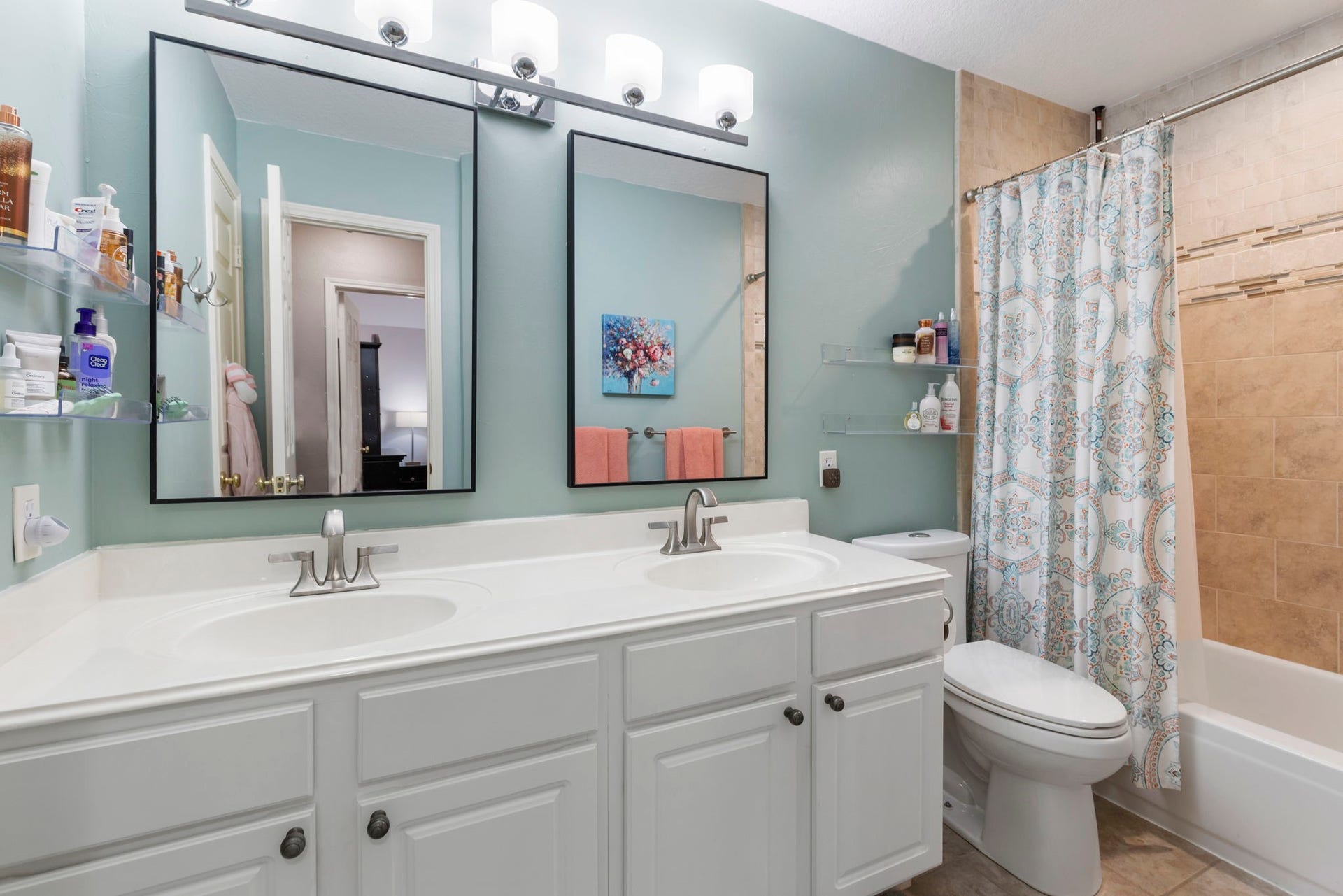98 W Night Heron Place, The Woodlands, TX 77382 The upstairs secondary bathroom features dual sinks, ample storage, and a functional layout designed for busy mornings.