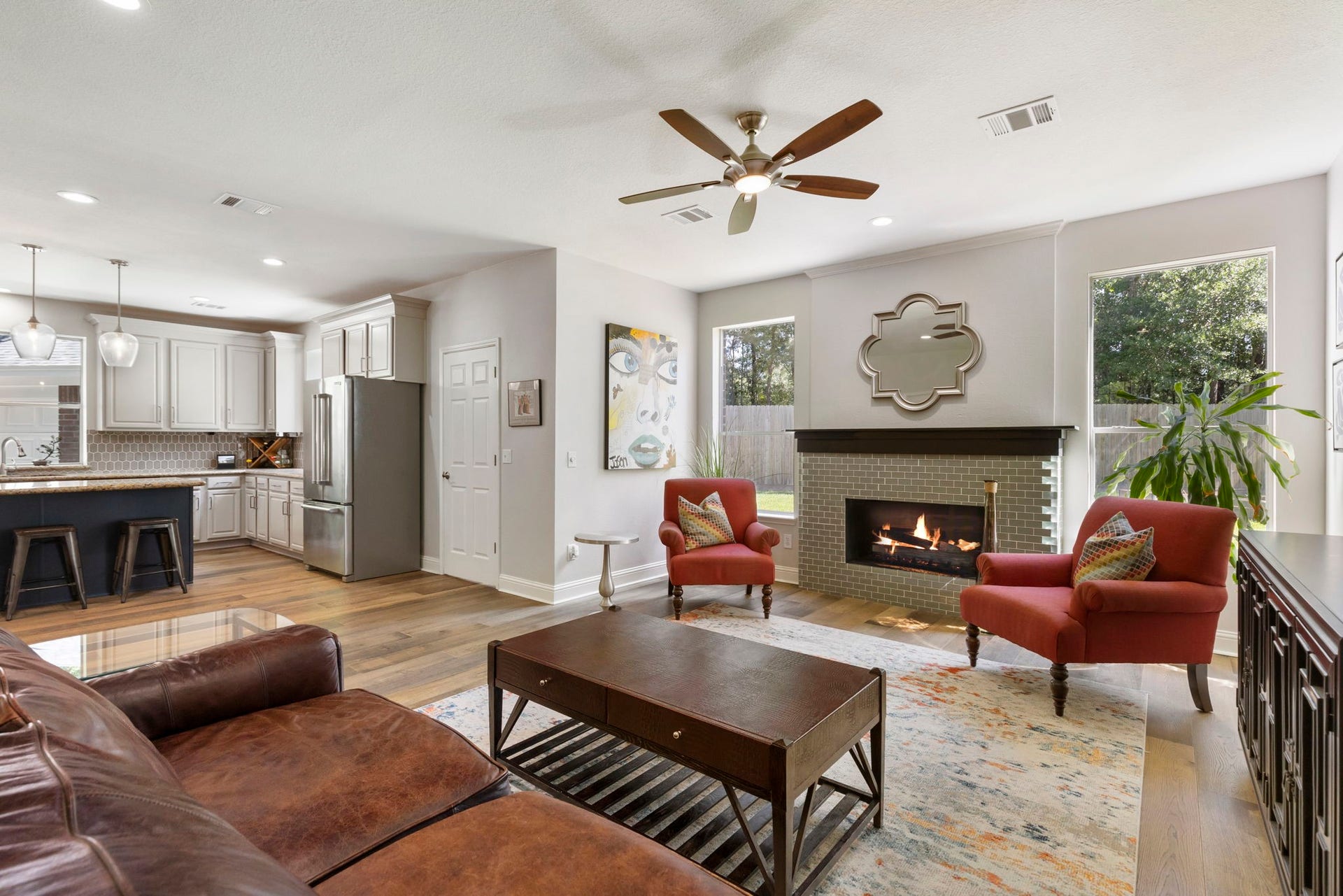 98 W Night Heron Place, The Woodlands, TX 77382 The open-concept design connects the living room and kitchen, creating a functional space for entertaining and gathering.
