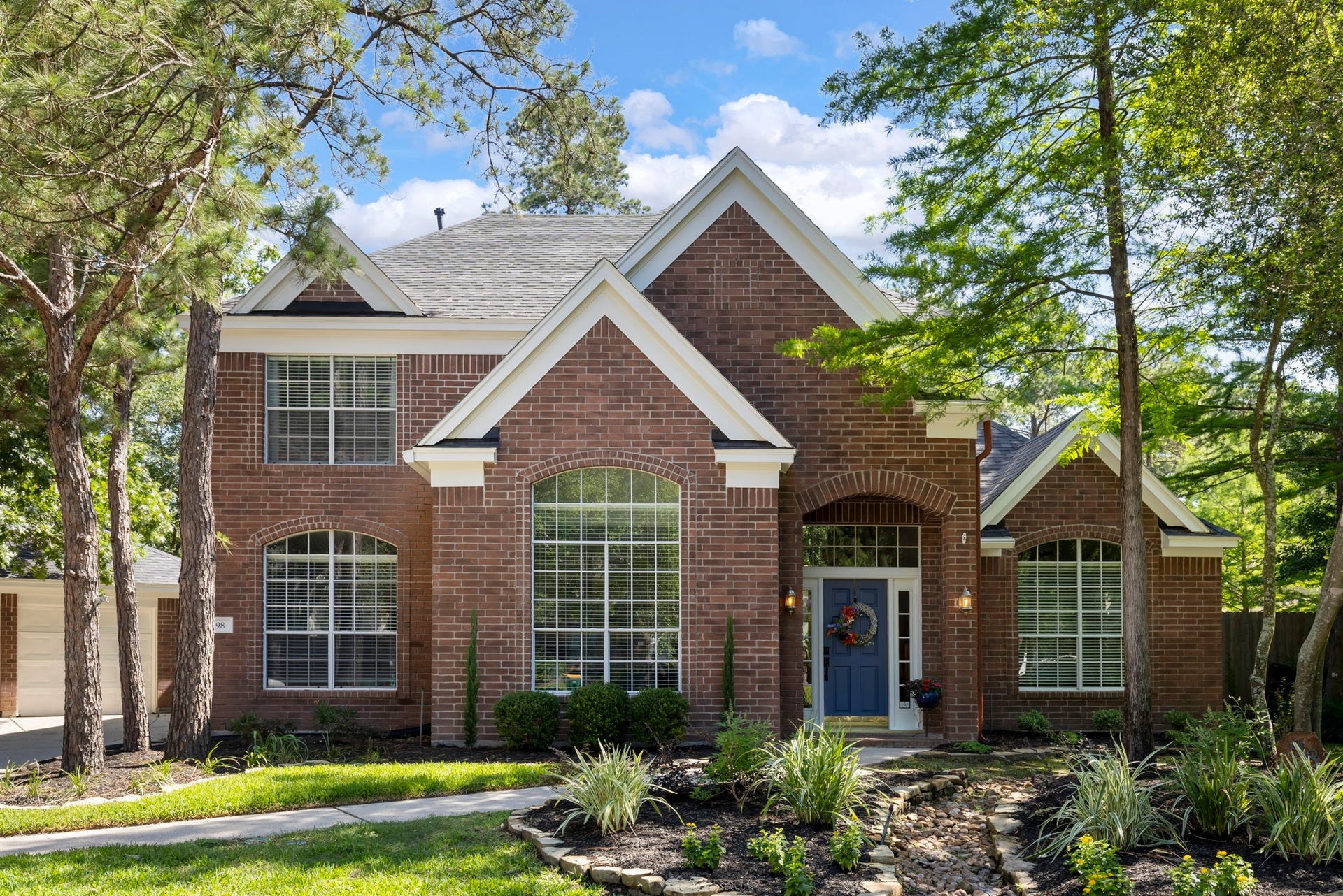 98 W Night Heron Place, The Woodlands, TX 77382 From the striking brick exterior to the soaring windows and lush landscaping, this home offers a warm and inviting first impression from the moment you arrive.