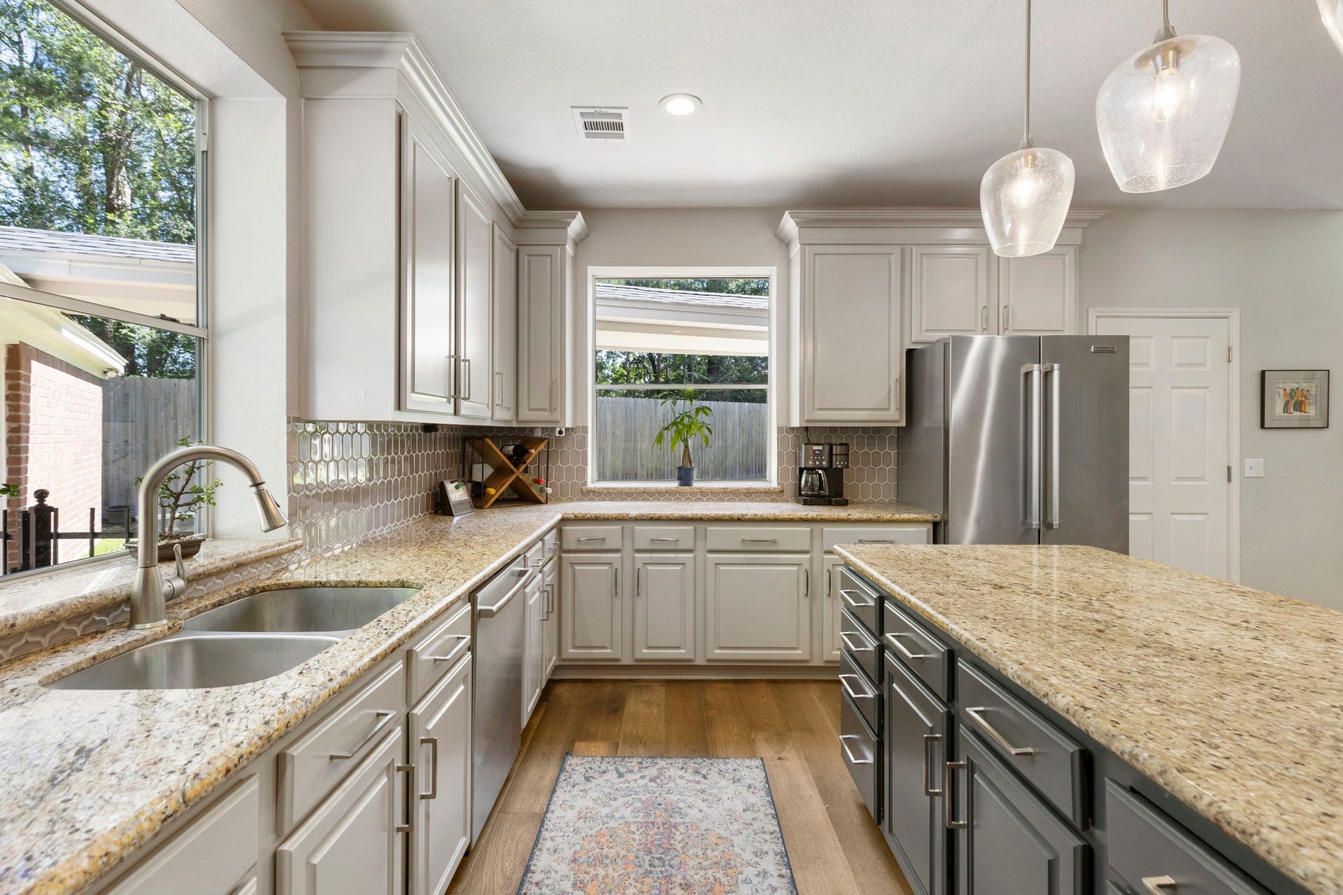 98 W Night Heron Place, The Woodlands, TX 77382 Extensive counter space, plentiful cabinetry, and natural light make this kitchen as functional as it is inviting.