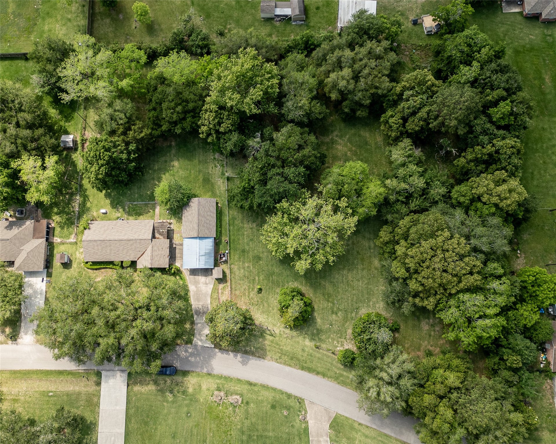 3804 Shady Lane, Santa Fe, TX 77517 Expansive aerial view showcasing this charming home nestled in the trees, offering privacy and tranquility. Ideal for nature lovers seeking a serene retreat.