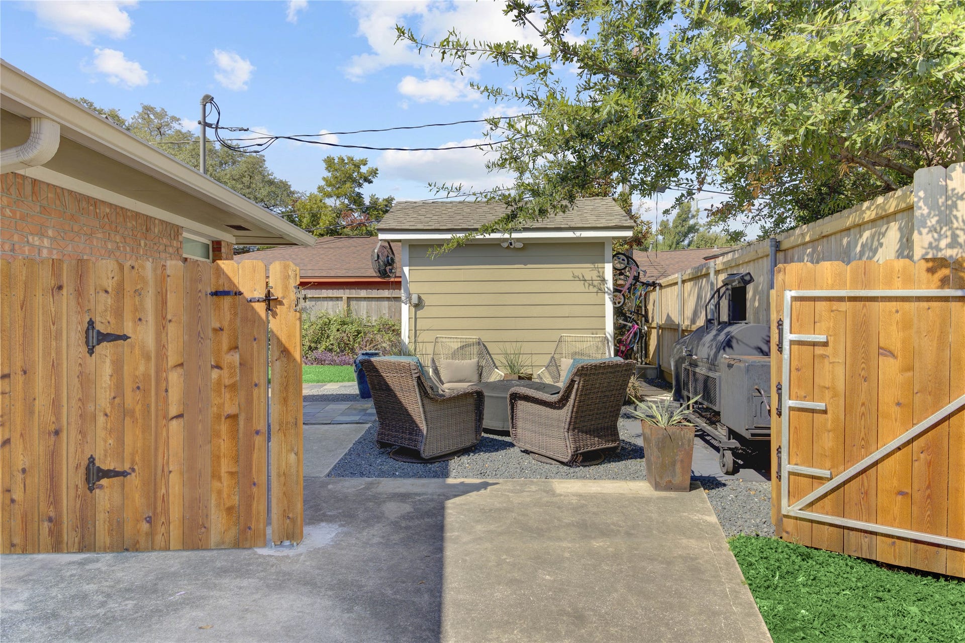 3007 Topham Circle, Houston, TX 77018 A view at the end of the driveway through the double-wide gate to the bonus backyard space.