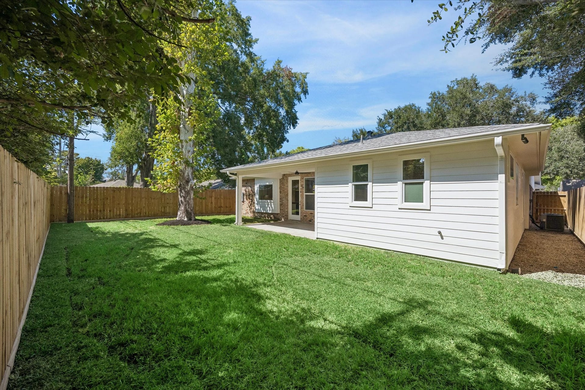 10659 Mayfield Road, Houston, TX 77043 The large tree provides natural shade, enhancing the yard's appeal. Whether you envision a lush garden, play area, or outdoor dining spot, this backyard can accommodate your lifestyle needs.