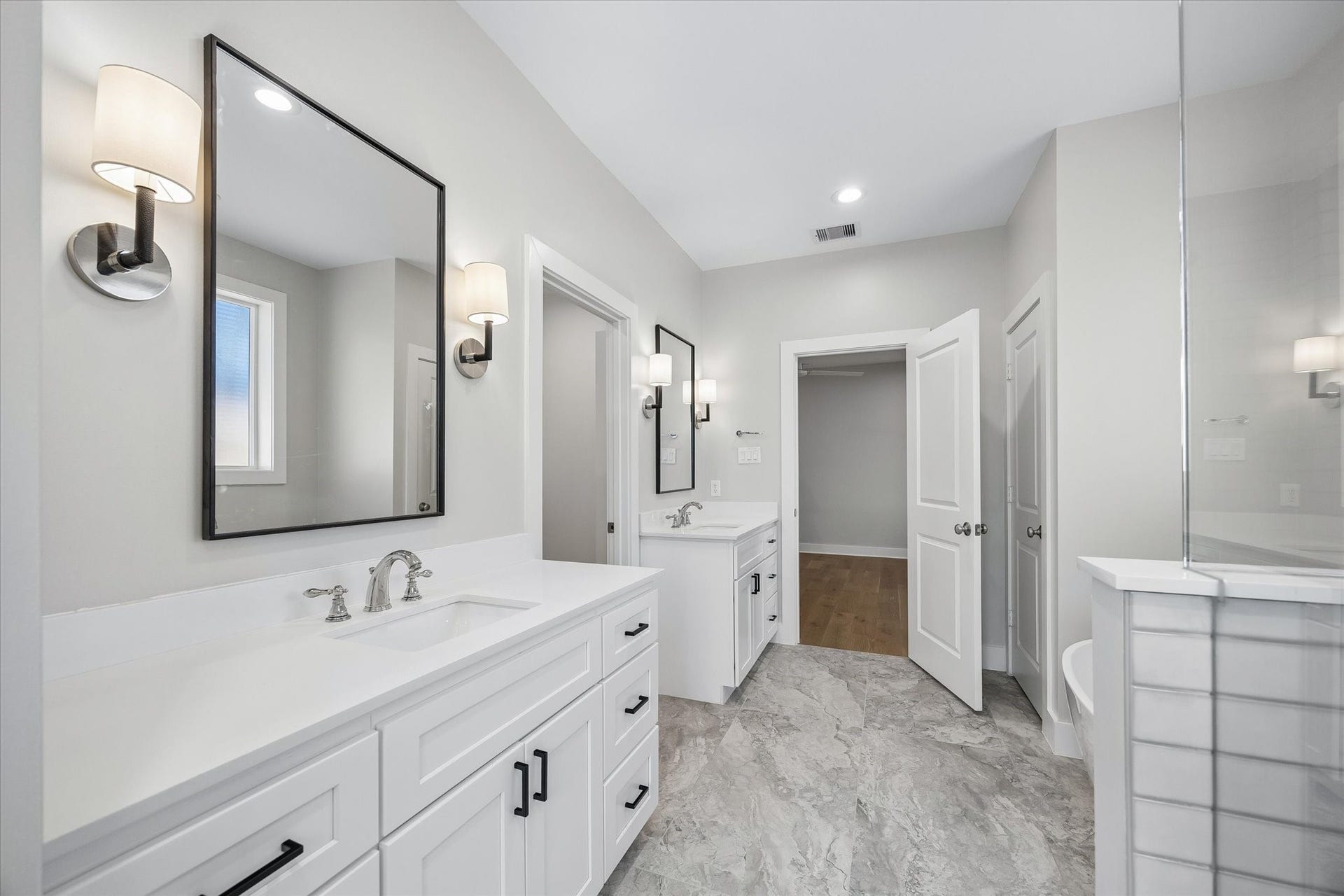 10659 Mayfield Road, Houston, TX 77043 Dual vanities provide ample storage and counter space .