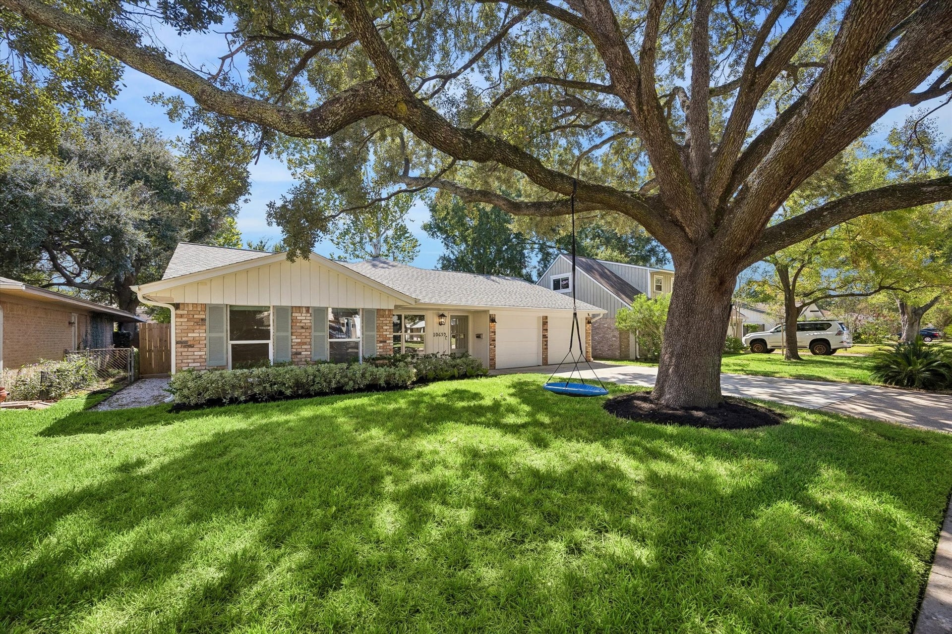 10659 Mayfield Road, Houston, TX 77043 A magnificent mature oak stretches across the front lawn, creating a canopy of shade and giving the property the established character buyers love in Spring Branch. The wide front yard offers plenty of green space while framing the home beautifully from the street.
