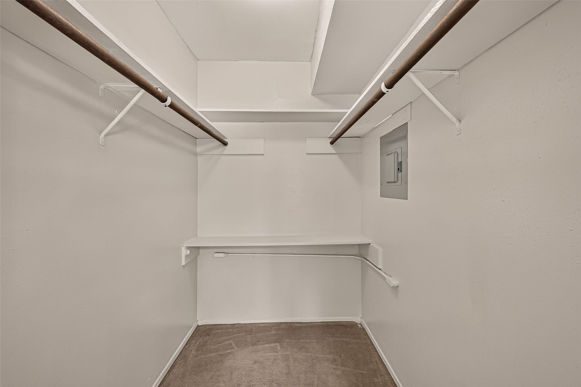 10555 Turtlewood Court, #1006, Houston, TX 77072 Spacious walk-in closet with dual hanging rods and a built-in shelf, perfect for organized storage.