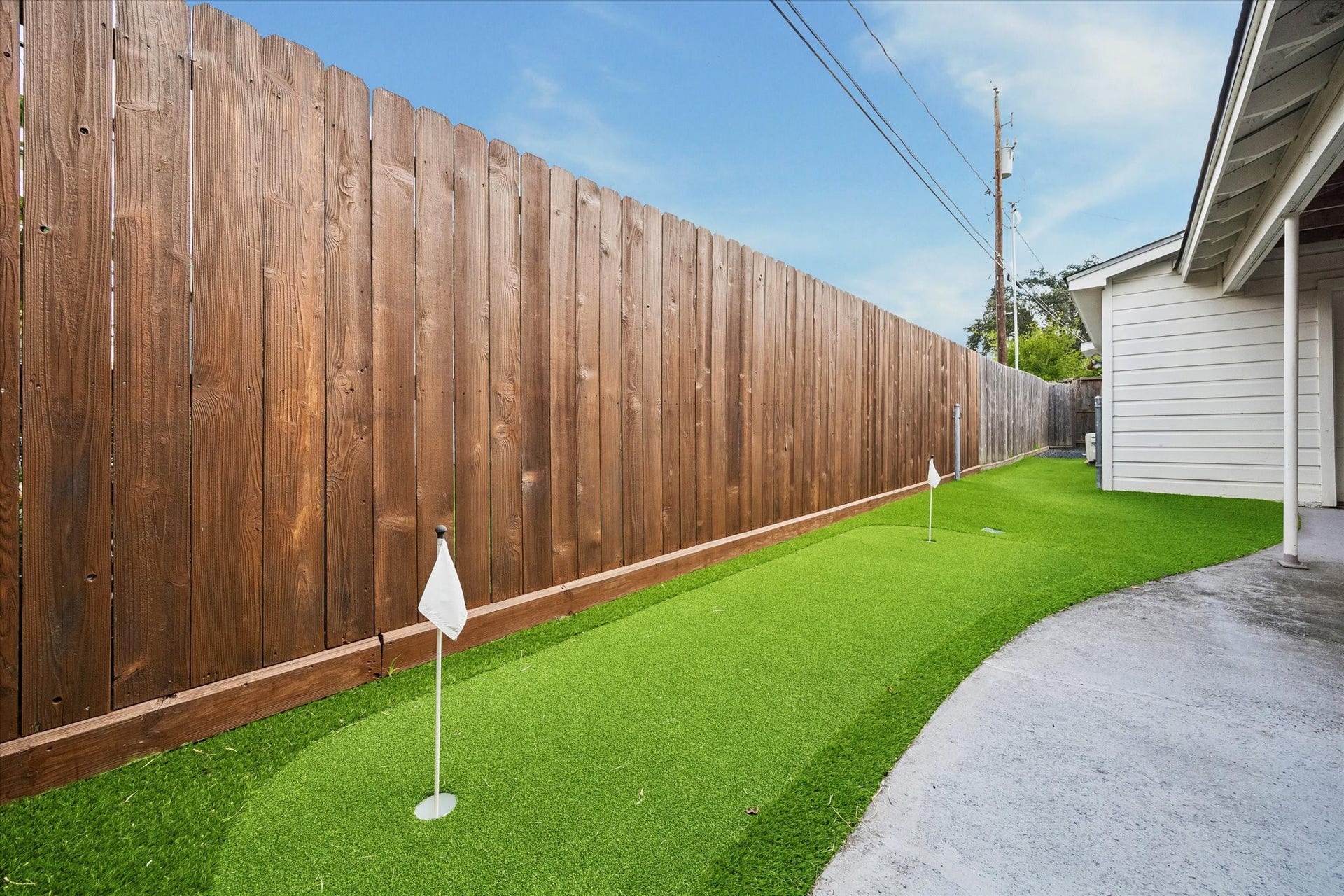 A private side yard with low maintenance turf offers extra outdoor space for recreation and play.