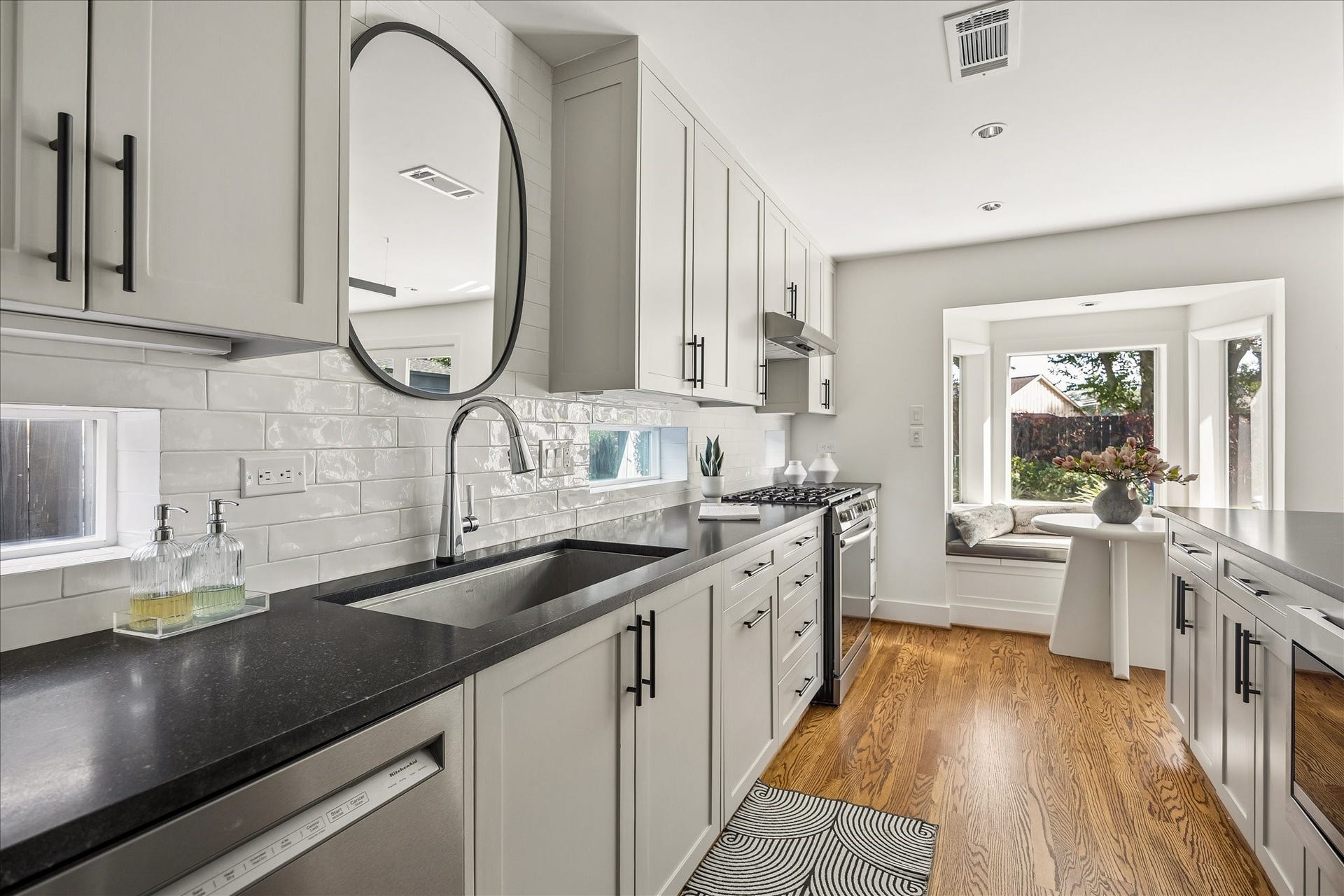 4130 Costa Rica Road, Houston, TX 77092 A sleek undermount sink, slim horizontal windows, and classic subway tile lend a clean, tailored finish to the kitchen.