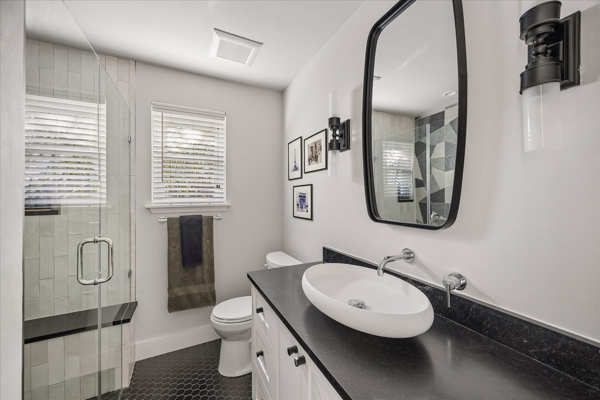 4130 Costa Rica Road, Houston, TX 77092 A contemporary vessel sink, wall-mounted faucet, and sleek black accents bring a sophisticated touch to the secondary bath.