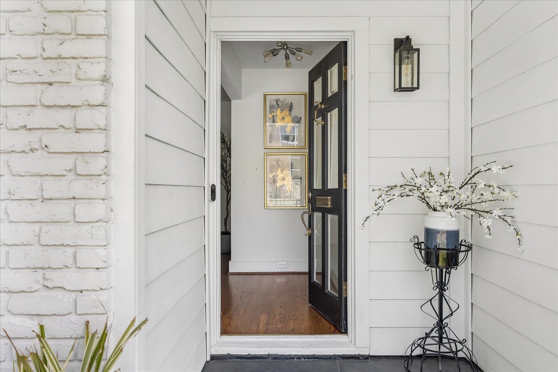 4130 Costa Rica Road, Houston, TX 77092 A handsome black front door, lantern-style lighting, and warm hardwood flooring just beyond offer a welcoming introduction.