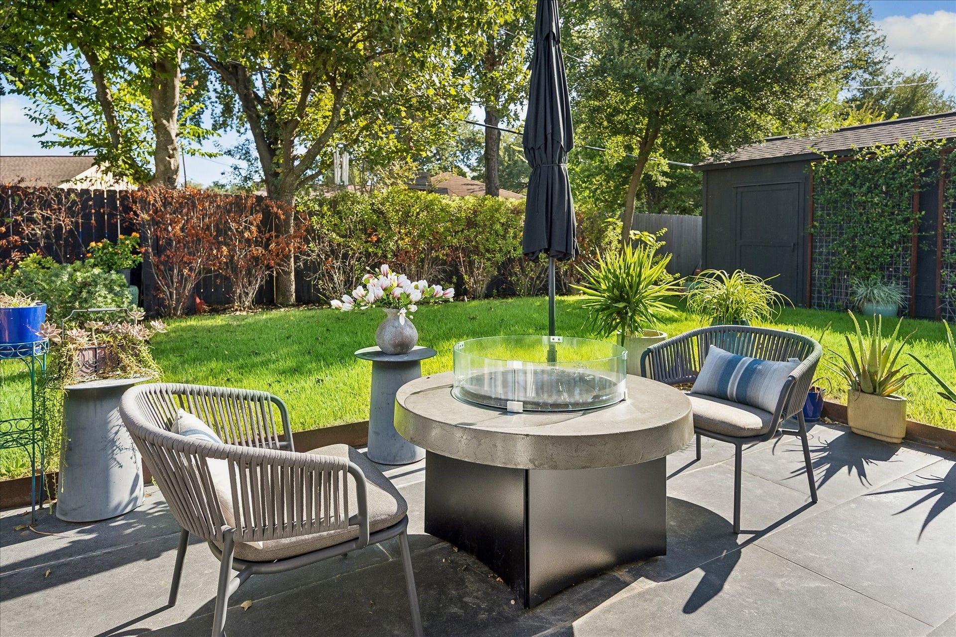 4130 Costa Rica Road, Houston, TX 77092 A lovely outdoor retreat featuring a spacious patio, lush lawn, and mature trees framed by thoughtfully maintained landscaping.