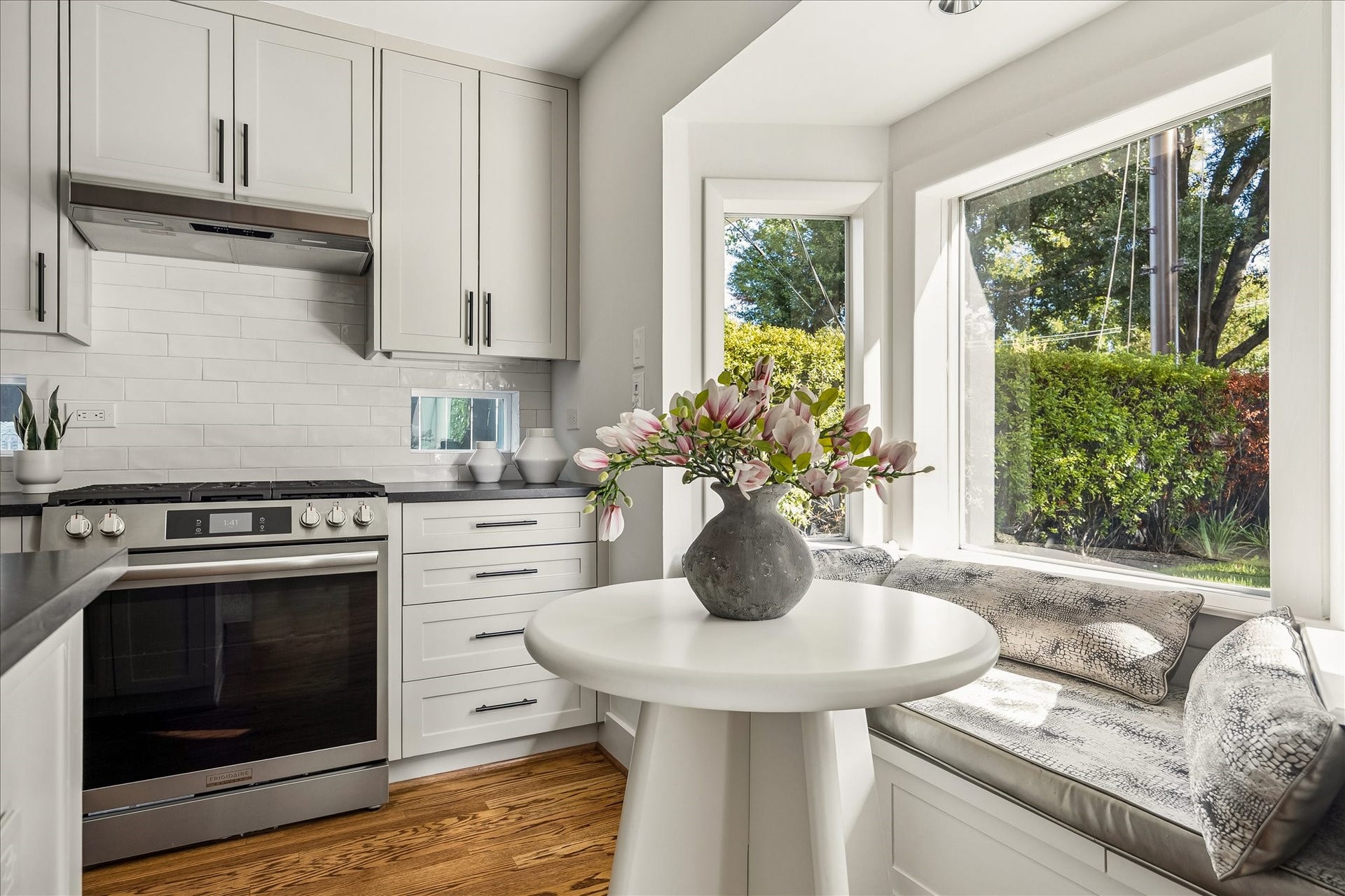 4130 Costa Rica Road, Houston, TX 77092 Stainless steel appliances, classic subway tile, and tailored cabinetry complement this sun-filled corner of the kitchen.
