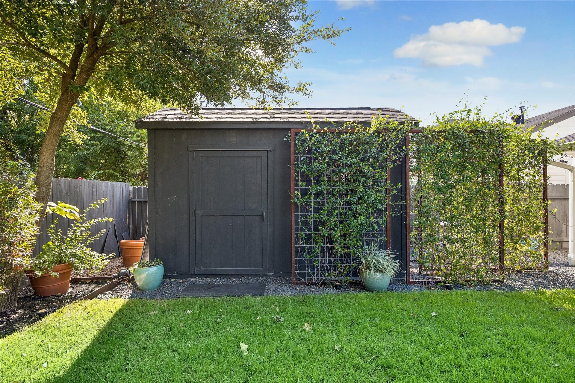 4130 Costa Rica Road, Houston, TX 77092 Tucked beneath mature trees, a charming garden shed with vine-covered trellis provides additional storage and character.