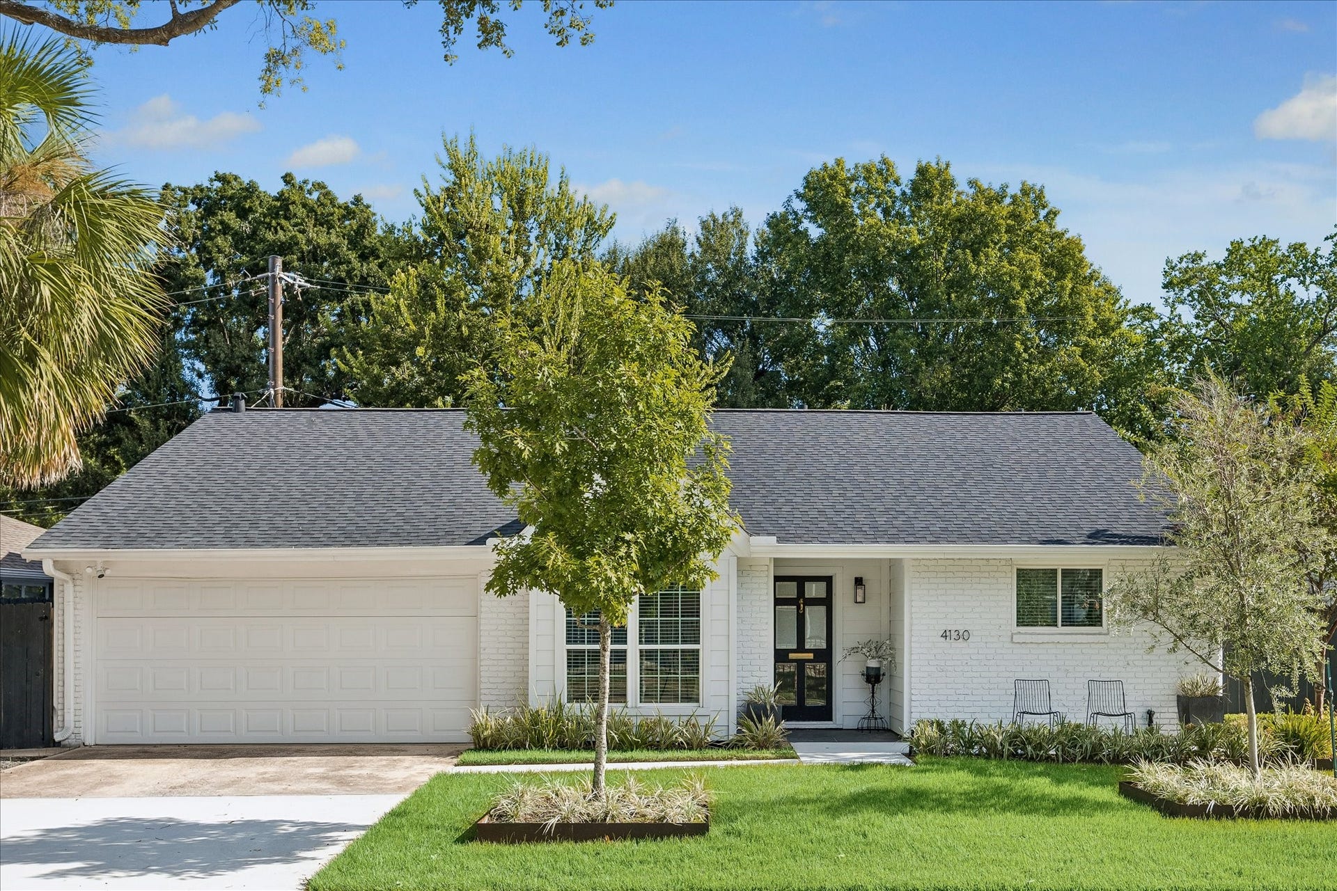 4130 Costa Rica Road, Houston, TX 77092 Another look at the home's classic architecture, crisp white brick, and beautifully maintained landscaping, all contributing to an inviting and memorable first impression.