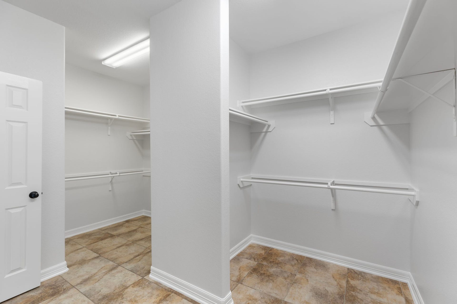 Primary walk in closet is very large and separated into two sections.