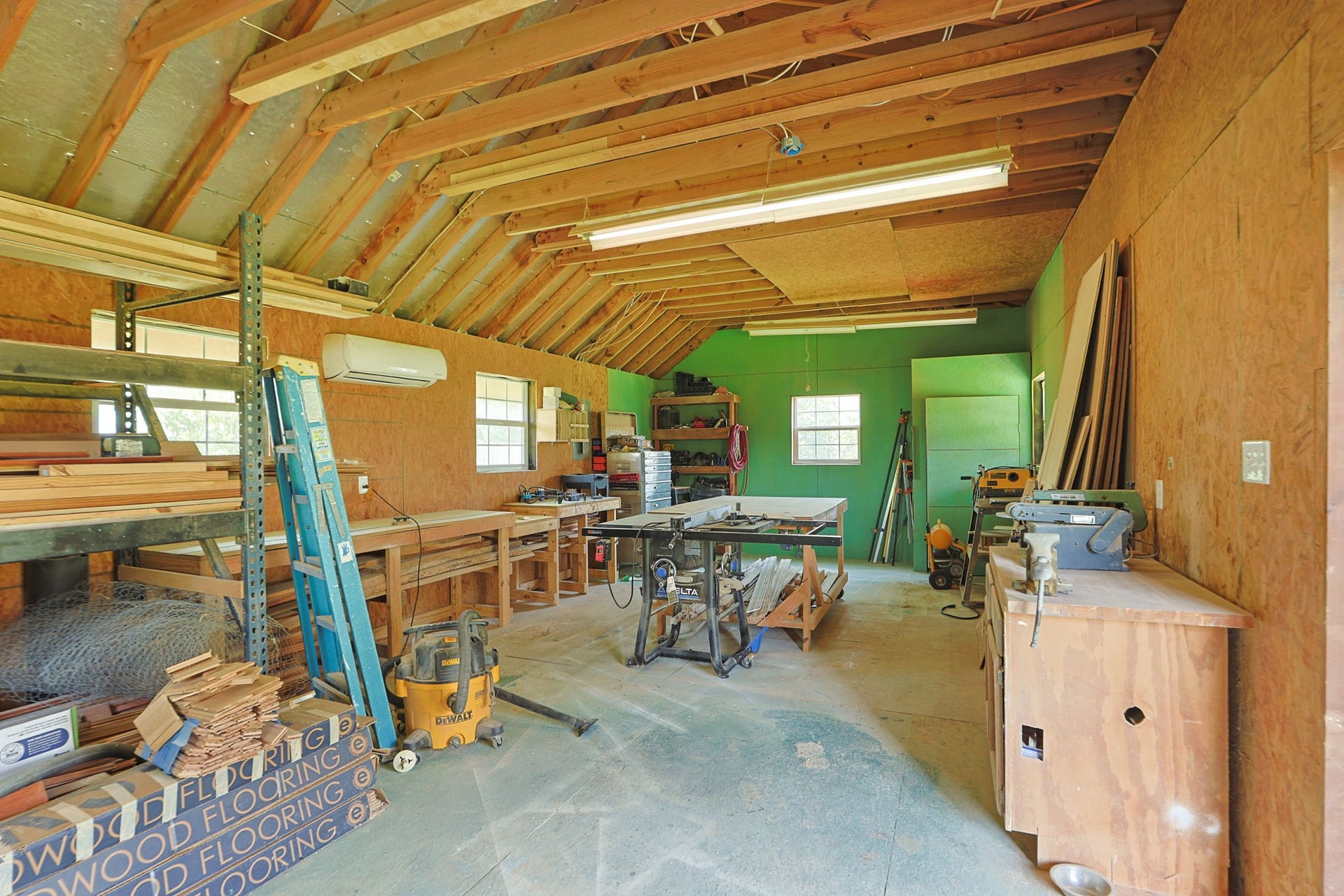 The walls of the workshop are insulated and there is a minisplit that cools the space. There is power supplied to the building.