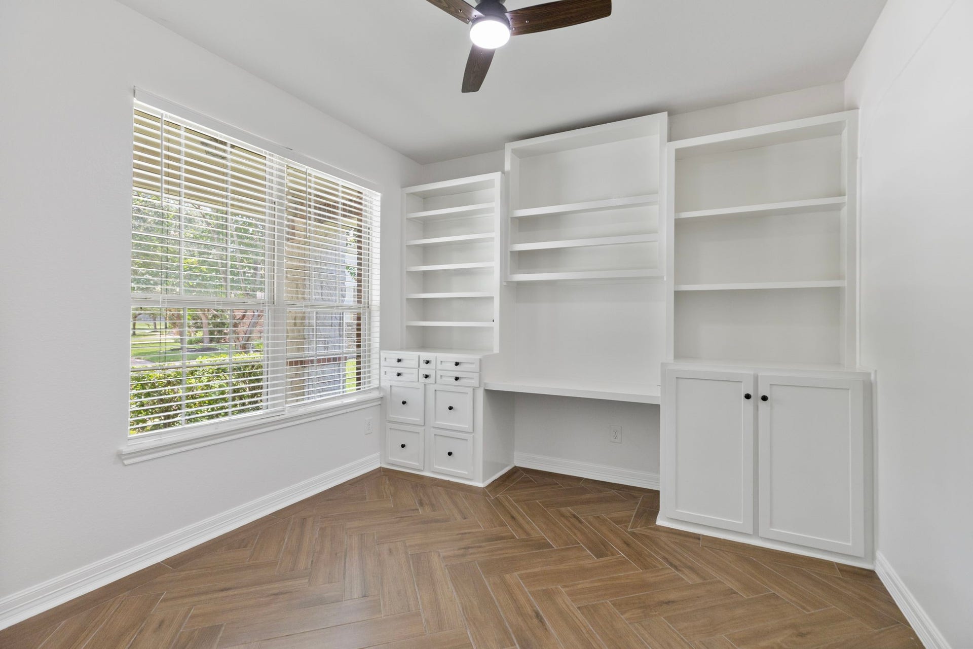 The office has built in book shelves, file drawers and desk.