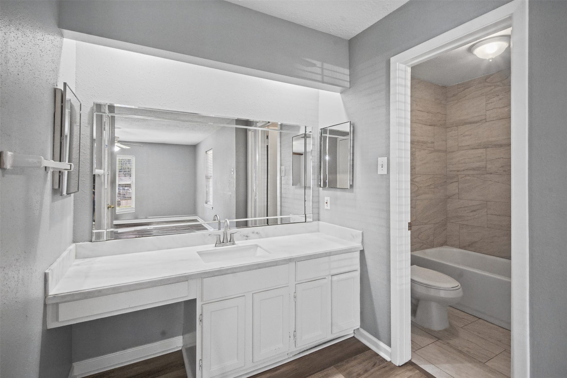 1323 Castle Glen Drive, Houston, TX 77015 Make your daily routine a little easier! A spacious vanity with ample counter space and storage sits just outside the bathroom, offering added convenience and functionality.