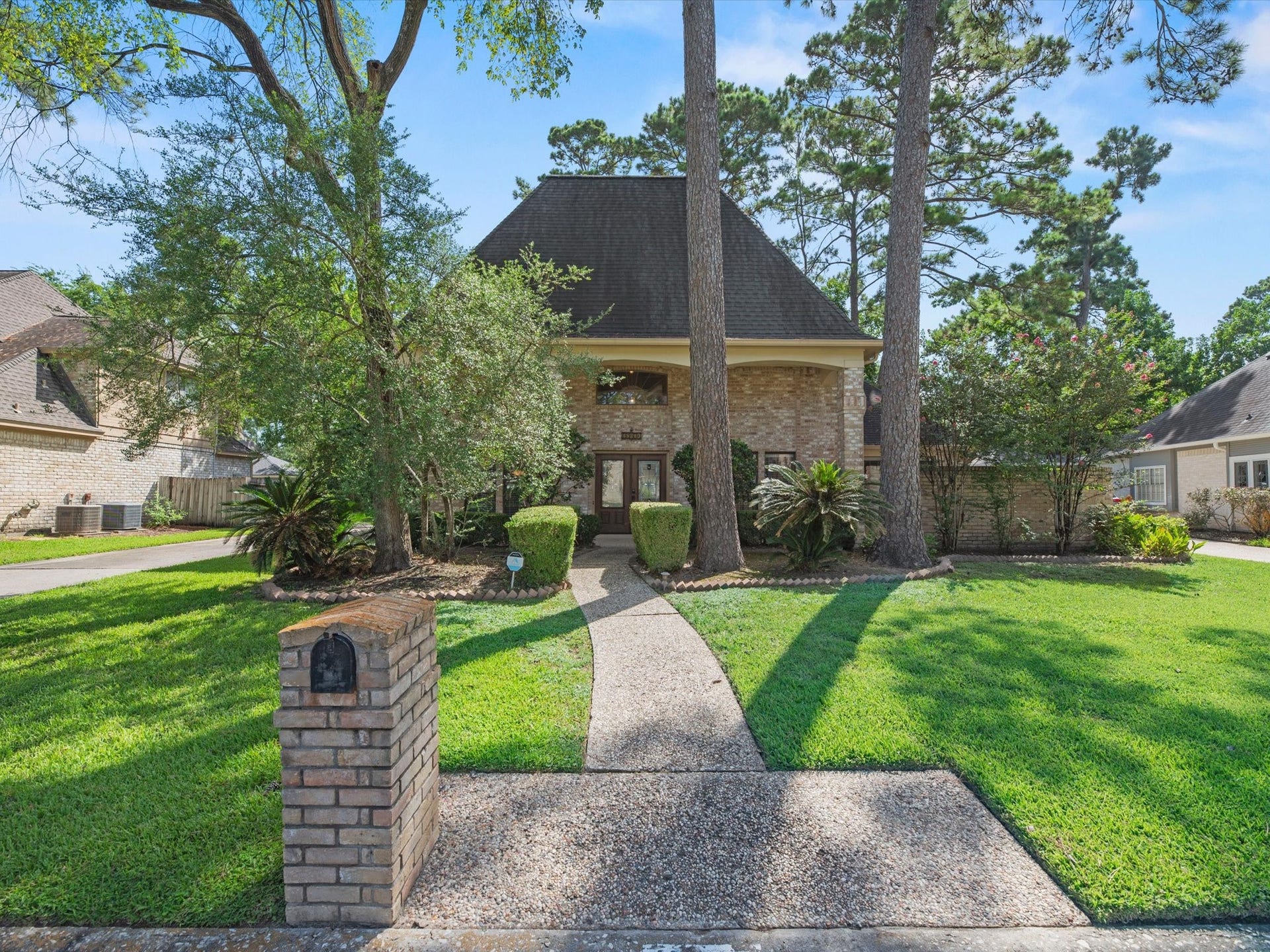 18310 Lake Oaks Drive, Spring, TX 77388 This charming two-story brick home offers timeless curb appeal with its classic architecture, mature shade trees, and a detached garage that adds both functionality and character. The stately brick exterior is complemented by established landscaping, creating a warm and inviting first impression. Towering trees provide natural beauty, shade, and privacy, making the property feel like a peaceful retreat. With its spacious layout and traditional design, this home blends enduring style with everyday comfort, o