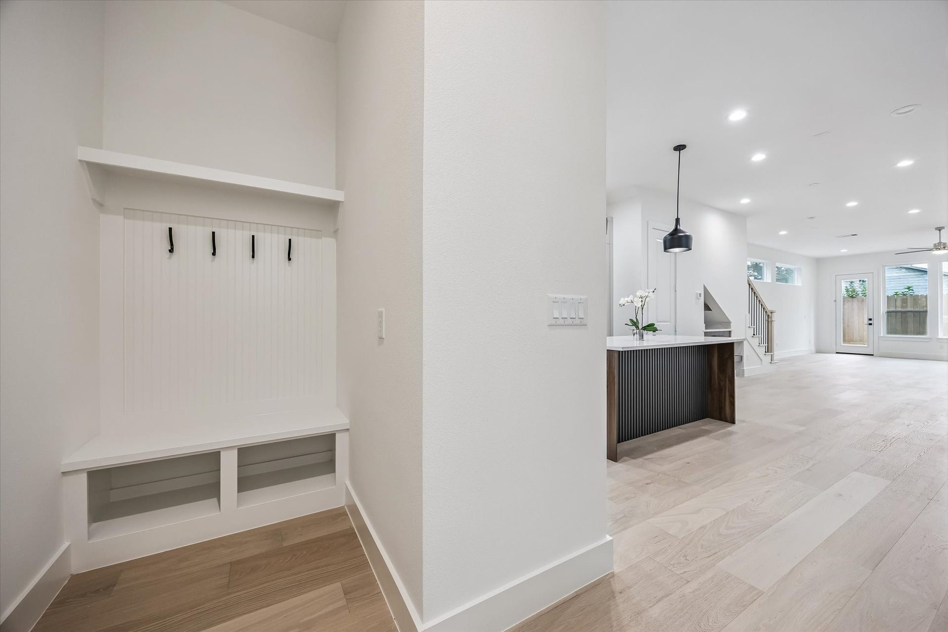 5339 Larkin Street, Houston, TX 77007 Bright and spacious open-concept living area with sleek light wood flooring, a modern kitchen island, and convenient entryway storage.
