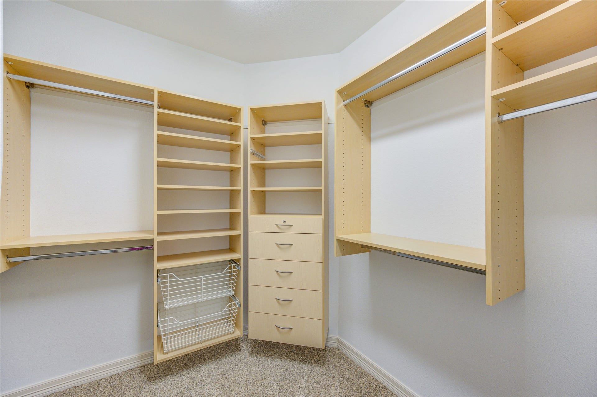 18614 Thomas Survey Drive, Cypress, TX 77433 Spacious primary closet thoughtfully designed with separate sections for her and him, offering ample shelving and organized storage throughout