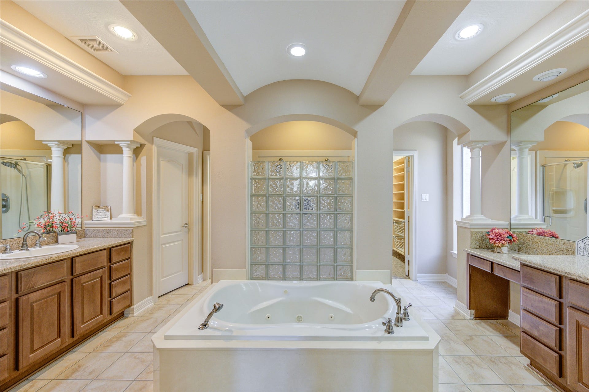 18614 Thomas Survey Drive, Cypress, TX 77433 Luxurious primary bathroom with split vanities, featuring a spacious hers side with generous counter space and a separate his area for added convenience