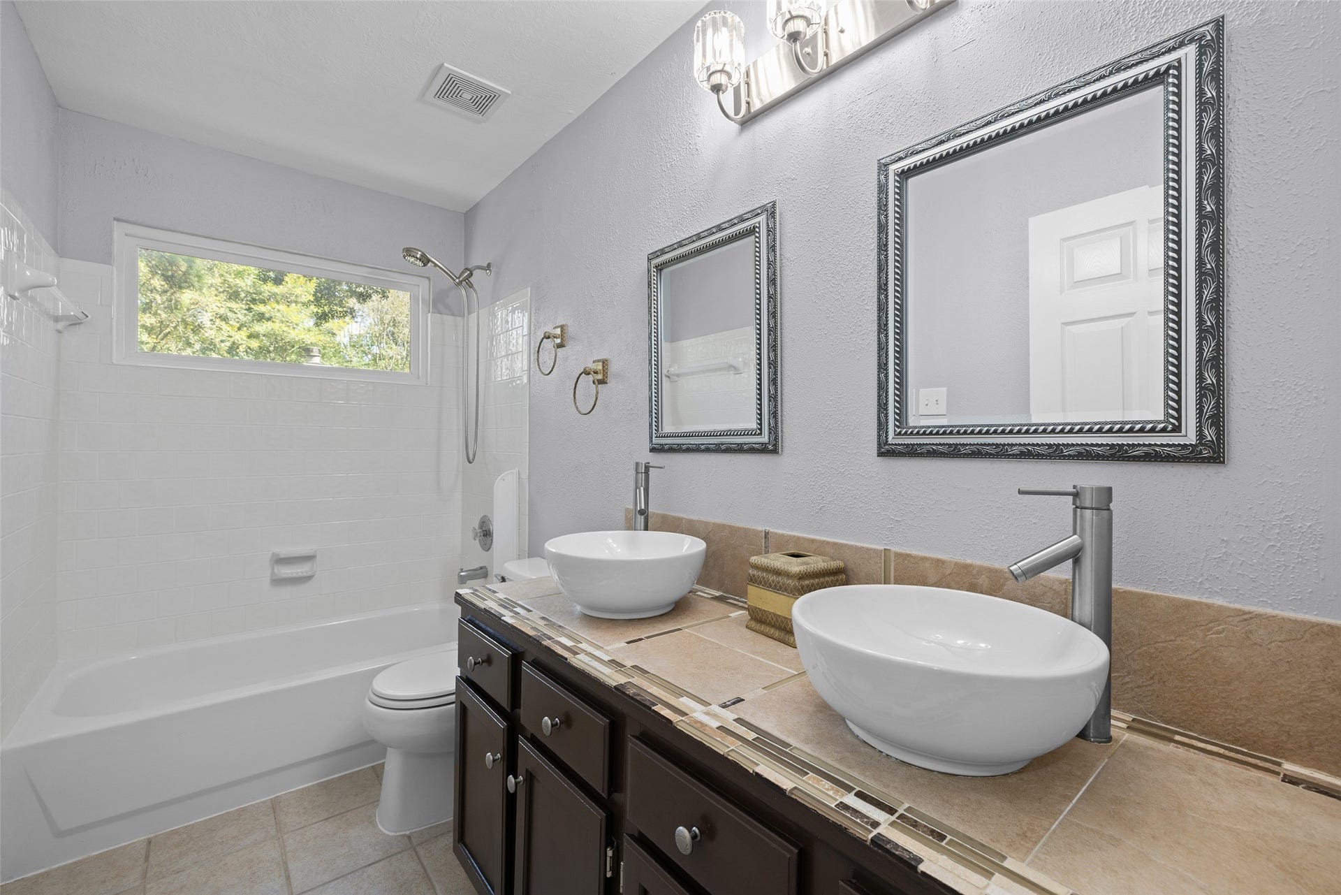 21 Long Hearth Place, The Woodlands, TX 77382 Guest Bath Dual sinks with a tub and shower combination.