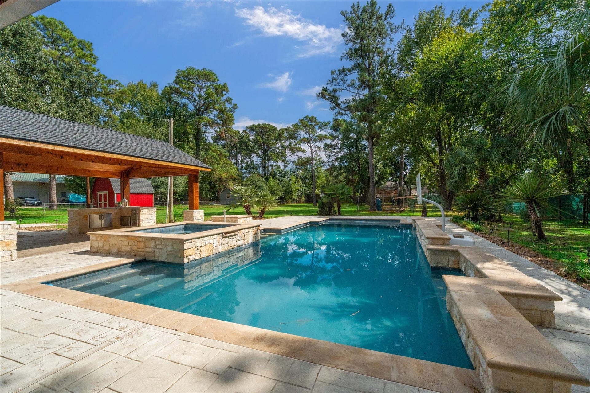 7119 Poole Road, Spring, TX 77379 A sun shelf, built-in pool benches, and a hot tub offer inviting spots to lounge, cool off, and unwind. You will have so many unforgettable moments here.