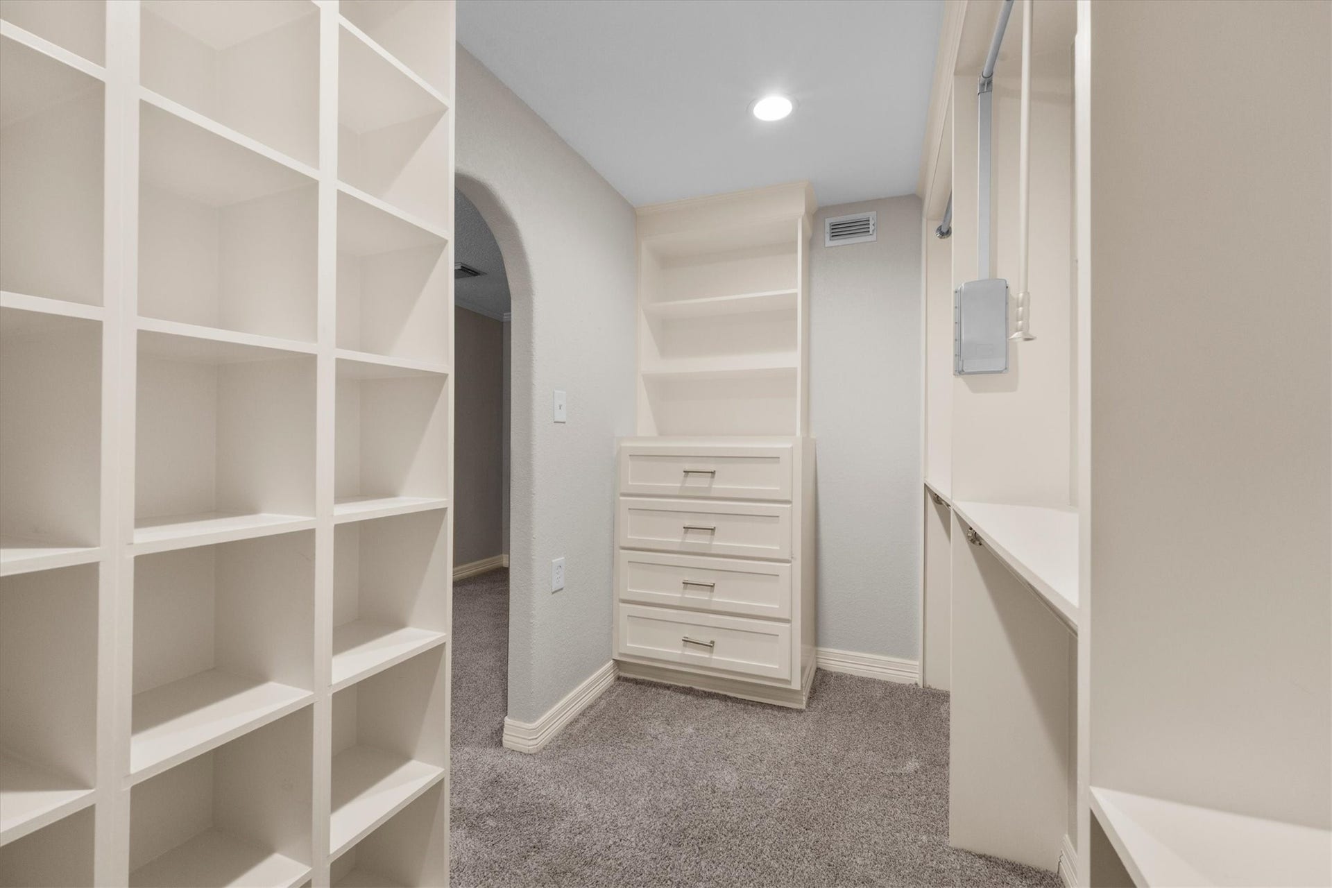7119 Poole Road, Spring, TX 77379 The spacious walk-in closet features custom storage designed to keep clothing and accessories organized, with plenty of room to make getting ready a breeze.