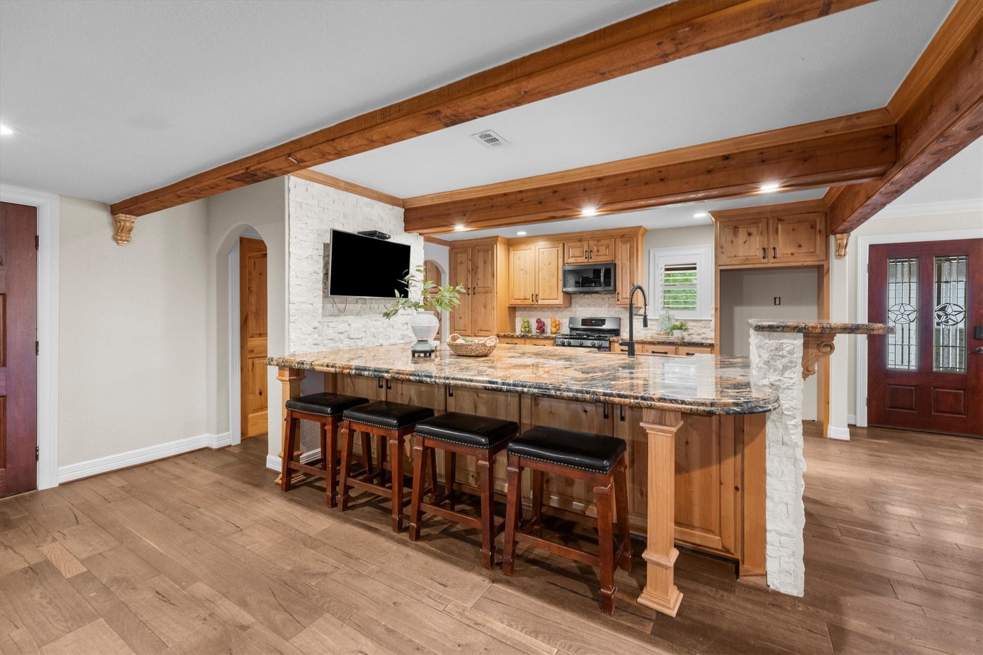 7119 Poole Road, Spring, TX 77379 Updated appliances, gorgeous granite countertops, and stone and wood accents give this kitchen a warm, inviting feel. Abundant storage and a massive island provide plenty of room.