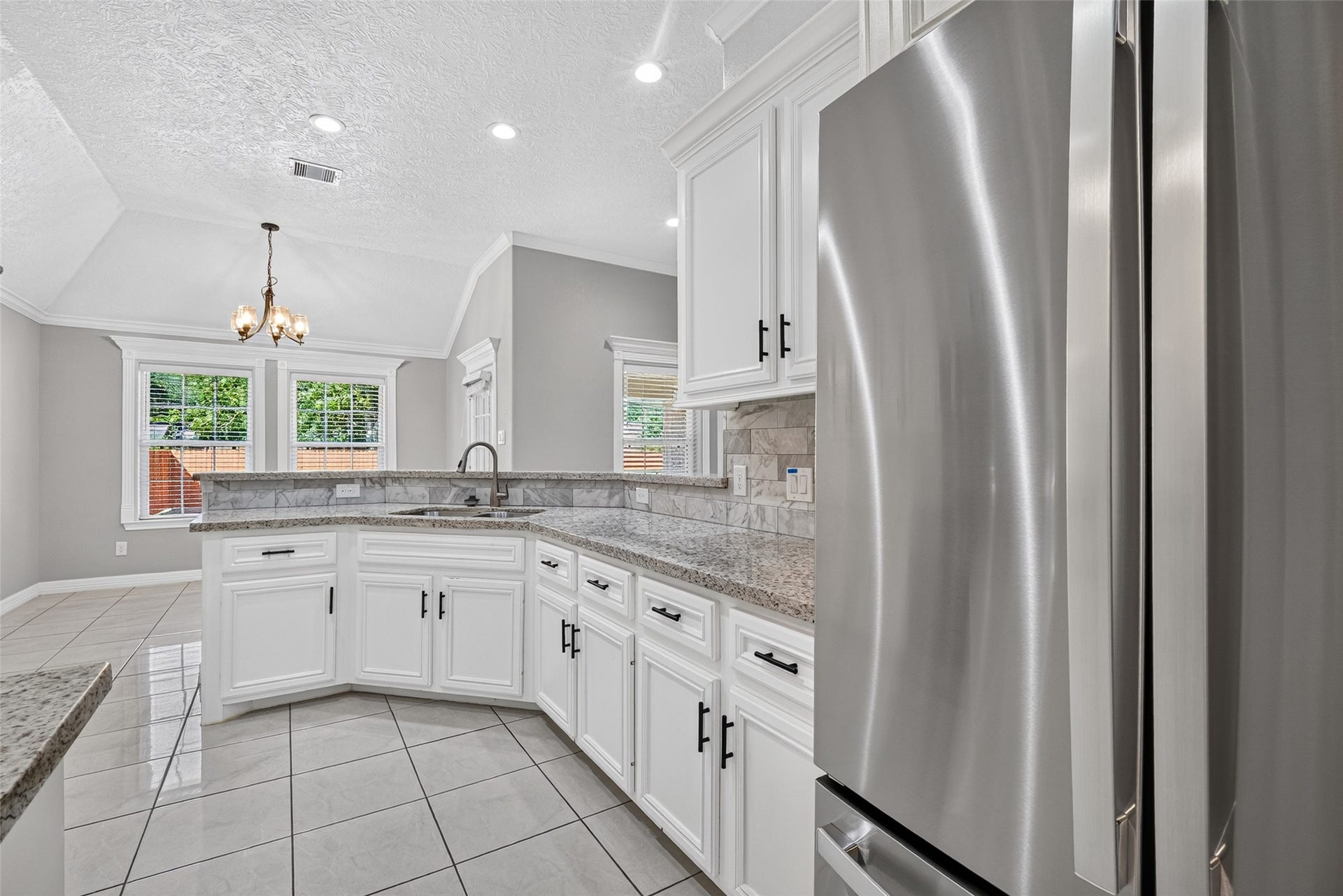 803 Avenue K, South Houston, TX 77587 Elegant kitchen featuring sleek stainless steel appliances, refrigerator included.