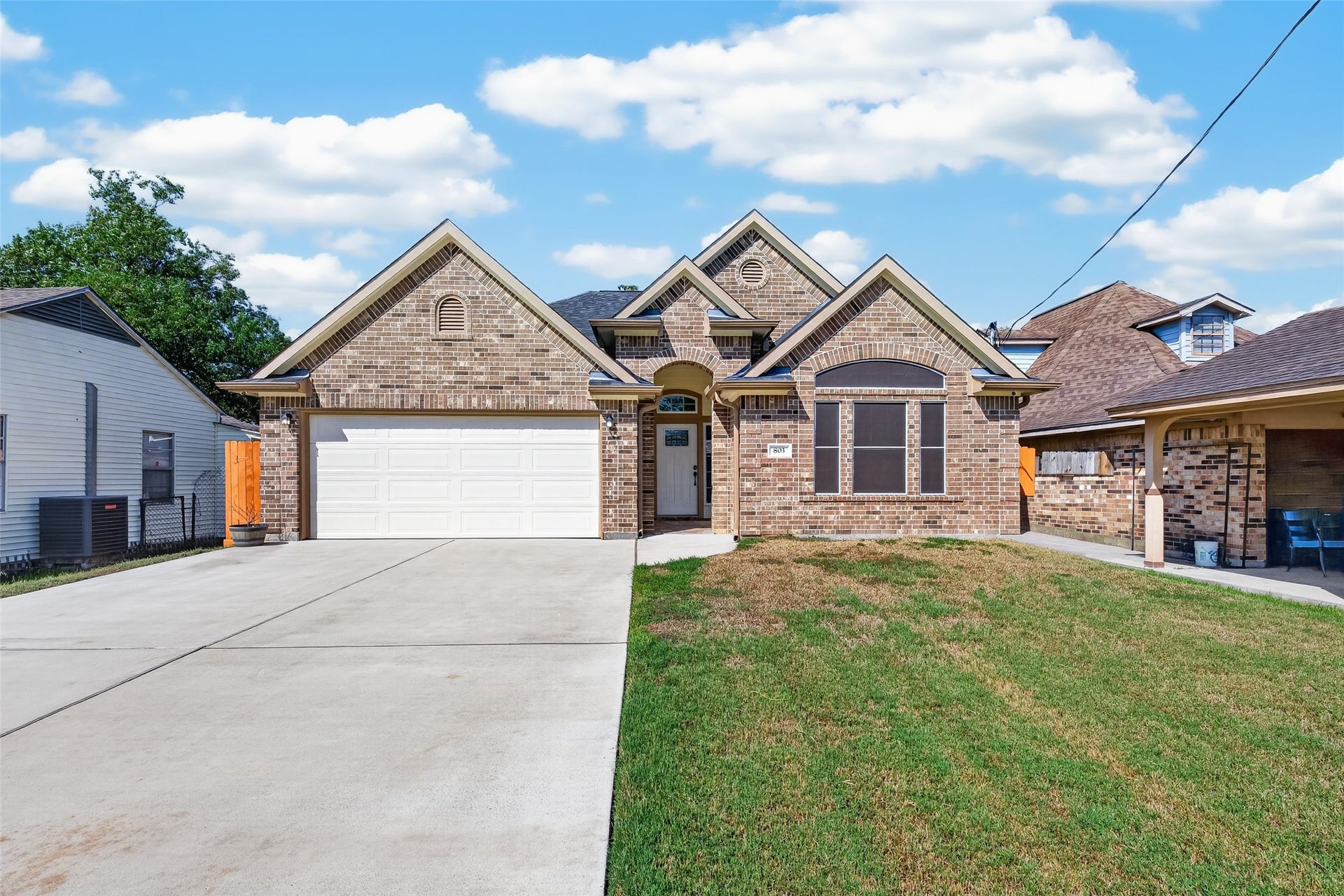 803 Avenue K, South Houston, TX 77587 Charming brick home with a welcoming facade, featuring a spacious double garage.