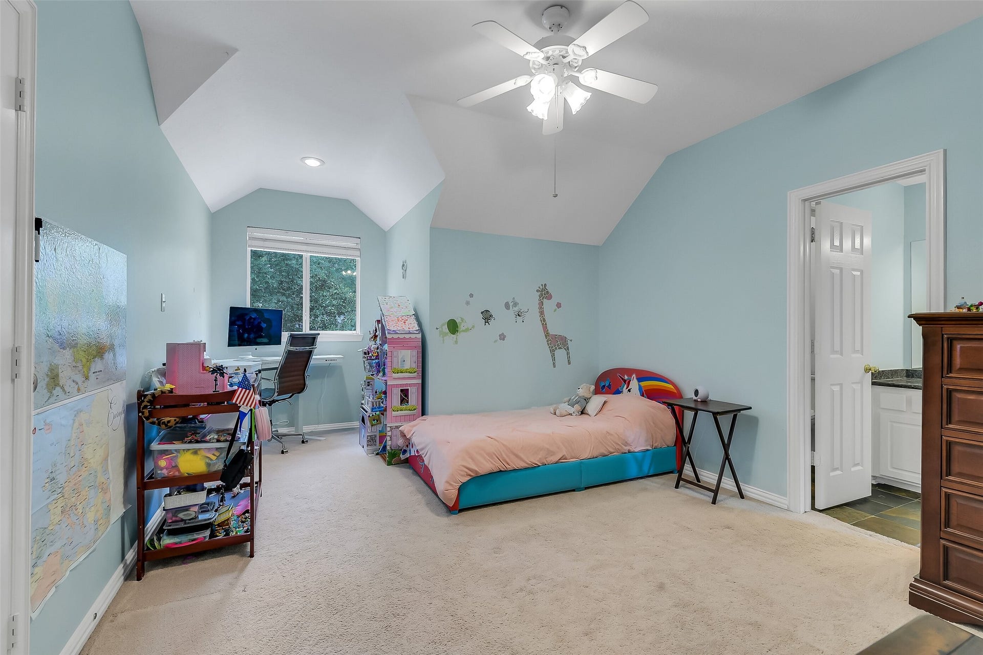 7 Larkspur Trail, The Woodlands, TX 77382 Spacious bedroom with soft blue walls, featuring a cozy bed, study area with desk, and a jack and jill . Perfect for creating a comfortable and personalized space.