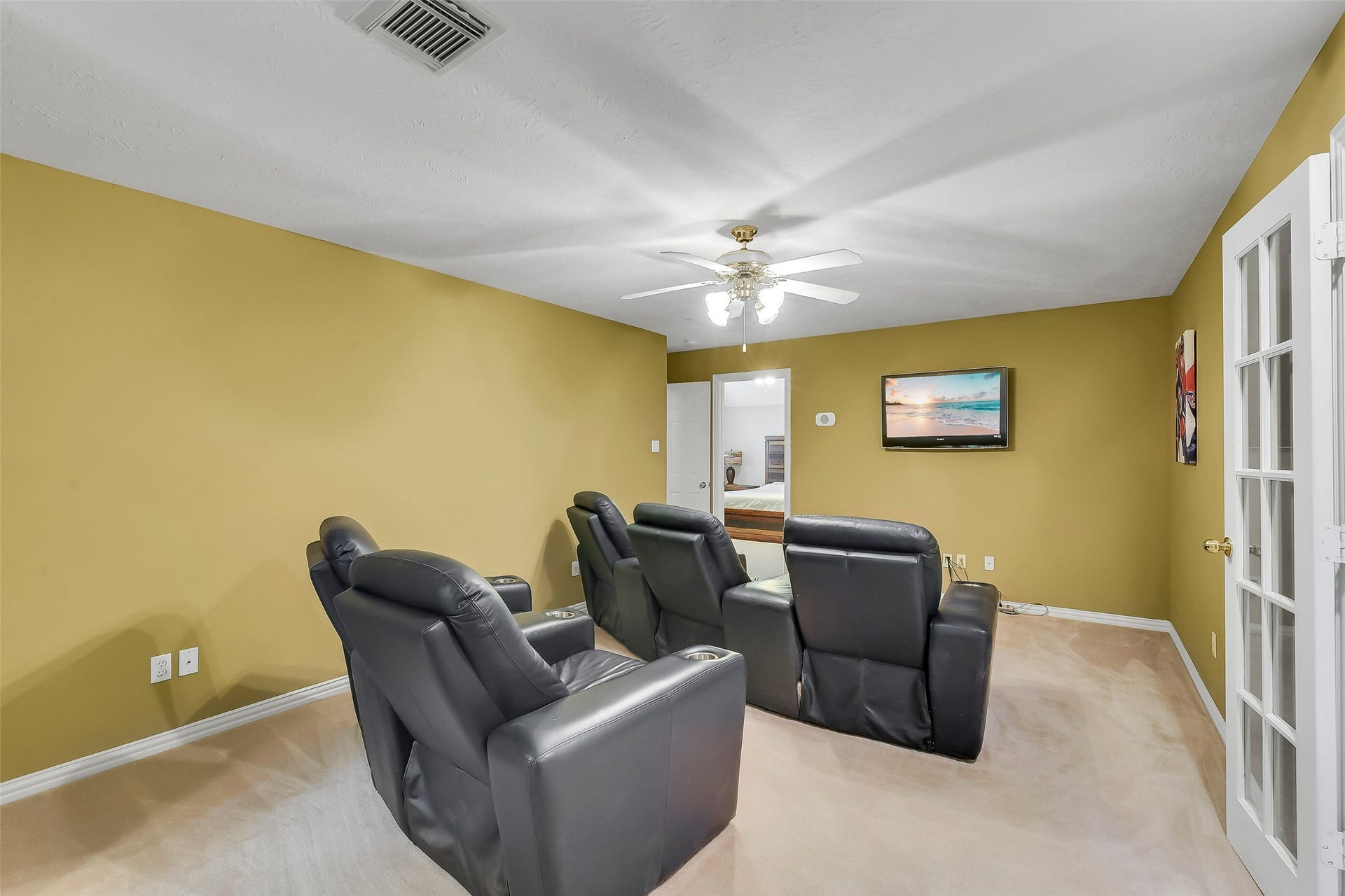 7 Larkspur Trail, The Woodlands, TX 77382 Cozy media room, a ceiling fan, and warm wall tones, perfect for movie nights.