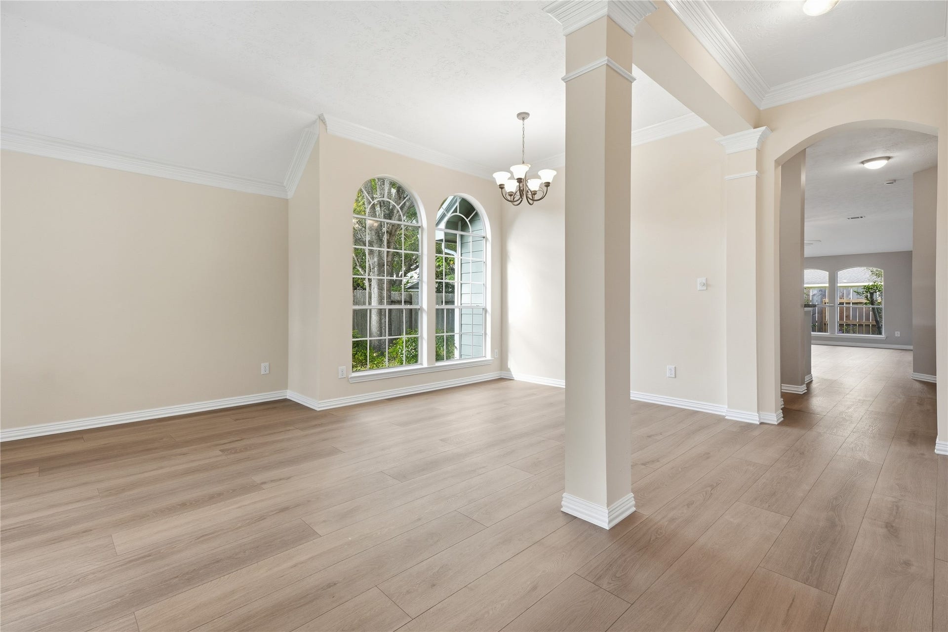 1411 Pebble Banks Lane, Seabrook, TX 77586 Welcoming entry showing off low maintenance luxury vinyl flooring, elegant crown molding and architectural support columns.
