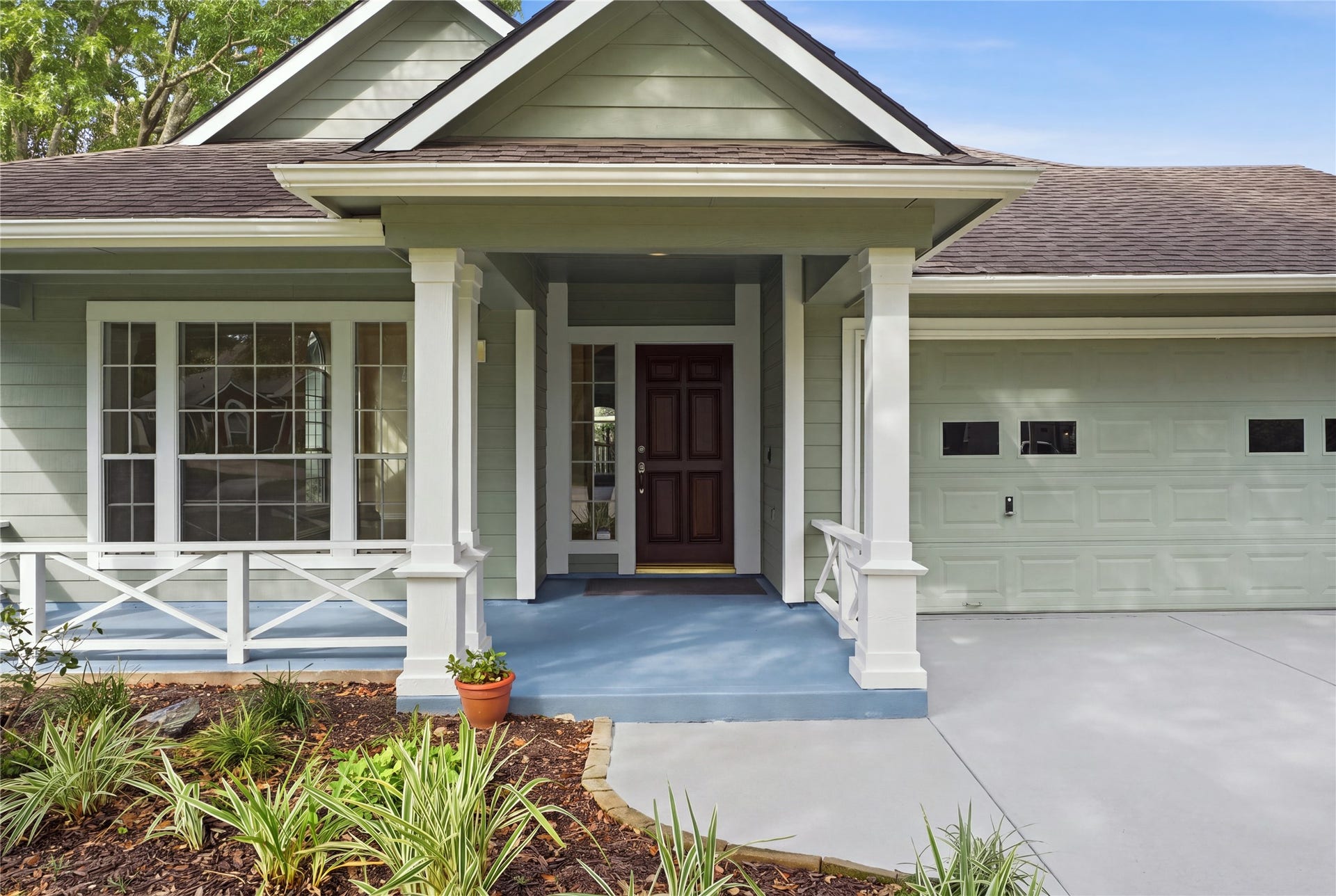 1411 Pebble Banks Lane, Seabrook, TX 77586 Craftsman inspired columns welcome you to this front porch with decorative railing.