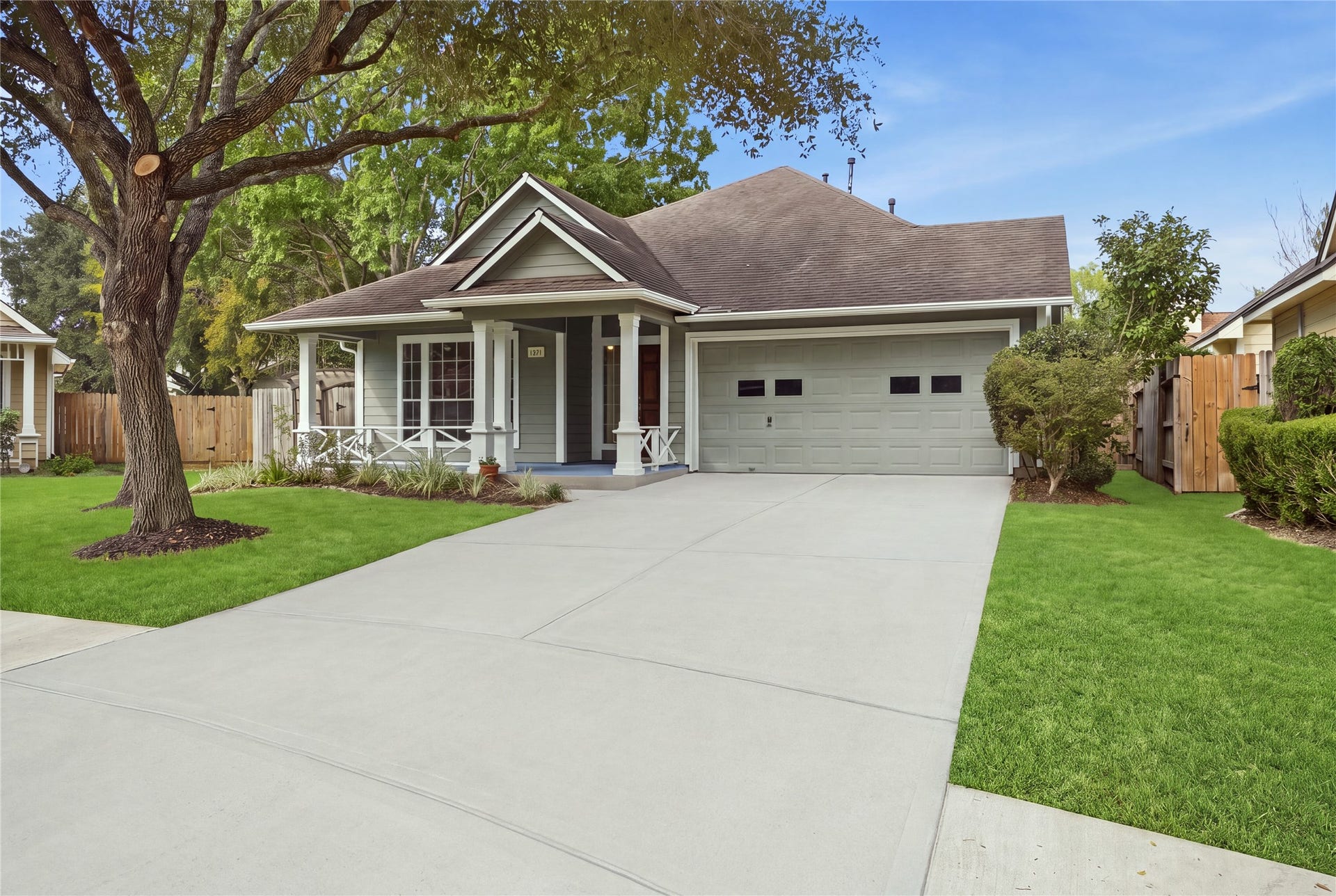 1411 Pebble Banks Lane, Seabrook, TX 77586 Double wide driveway and mature oak trees provide beautiful curb appeal.