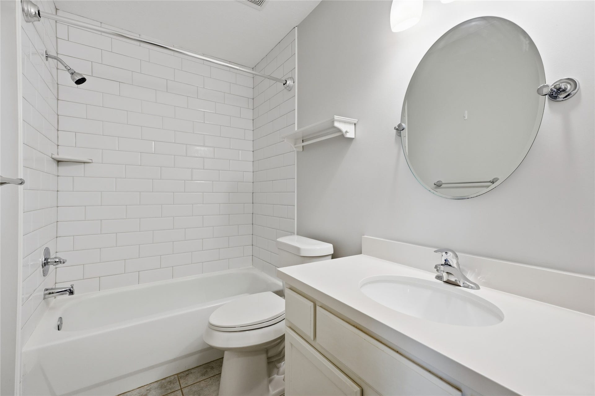 1411 Pebble Banks Lane, Seabrook, TX 77586 Secondary bathroom complete with tub/shower combination detailed with classic white subway tile. New toilet just installed.