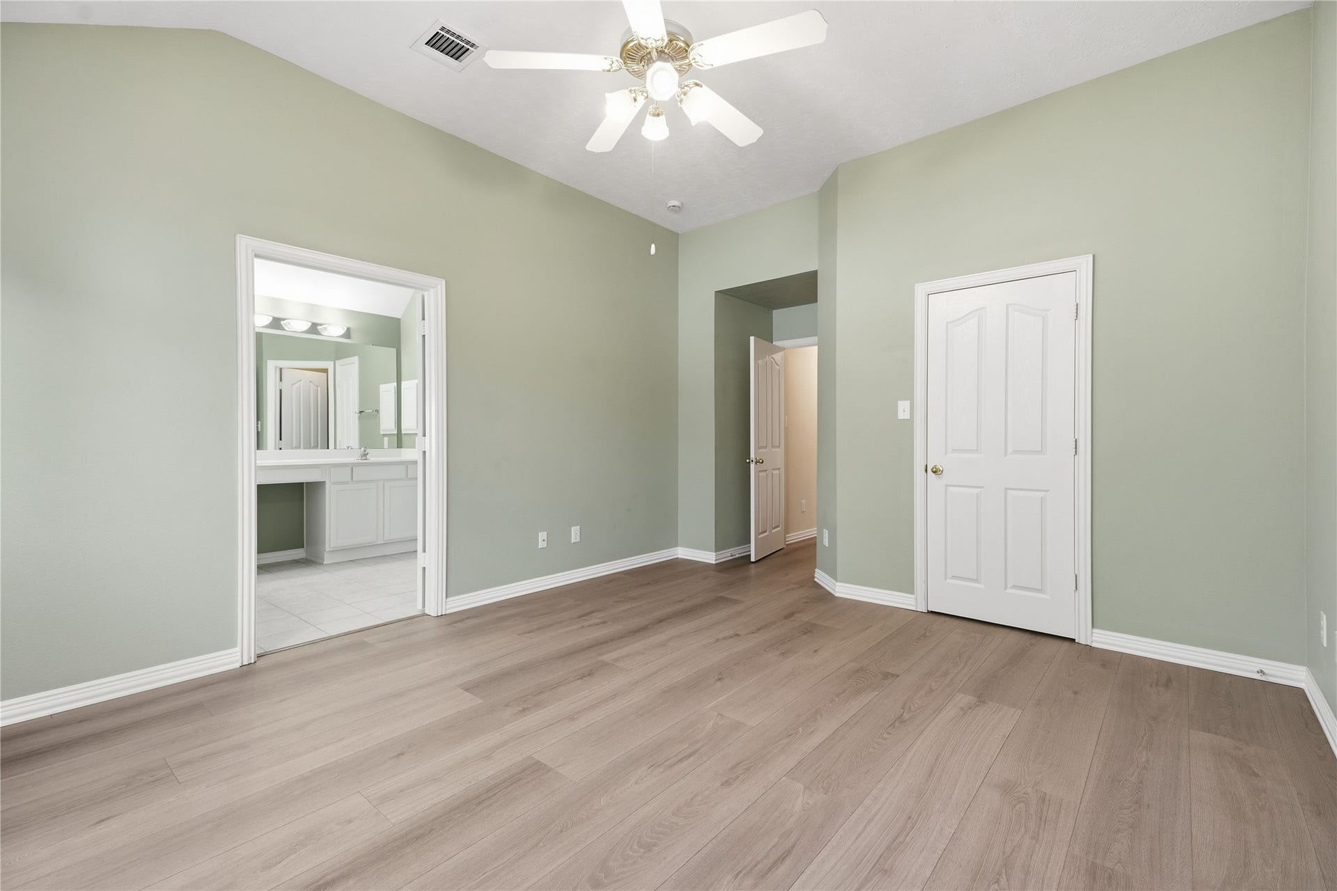 1411 Pebble Banks Lane, Seabrook, TX 77586 Alternate view of primary bedroom showcasing double doors leading to the en-suite bathroom.