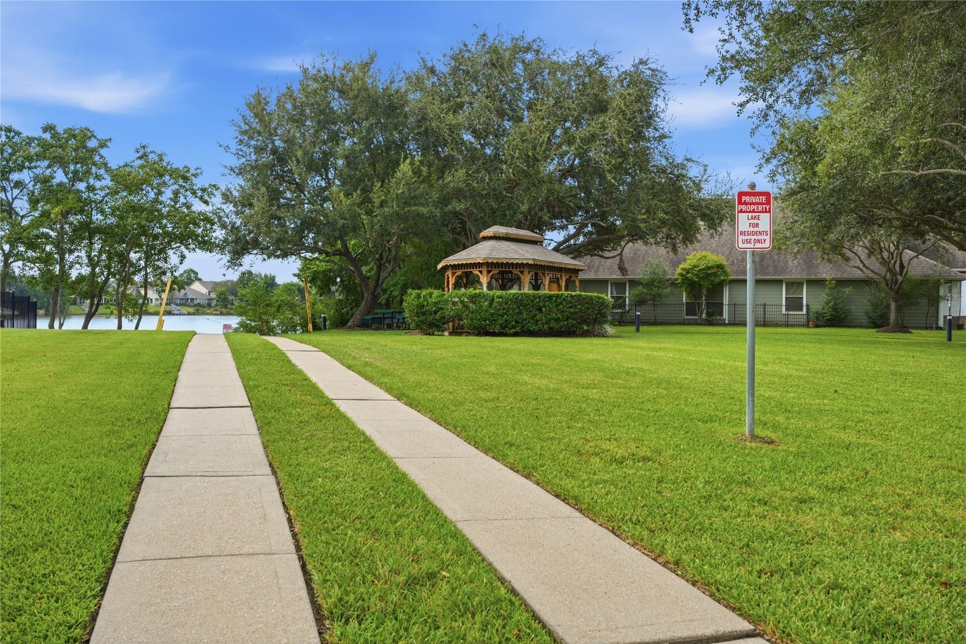 1411 Pebble Banks Lane, Seabrook, TX 77586 Community Park area with concrete walking path leading toward a scenic neighborhood lake and a charming gazebo.
