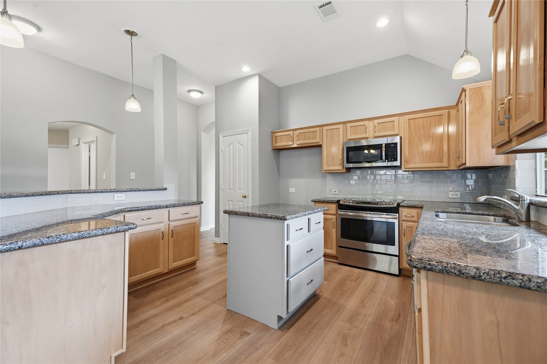 1411 Pebble Banks Lane, Seabrook, TX 77586 Functional kitchen design highlighting stainless steel appliances, granite countertops, and extensive cabinet storage.